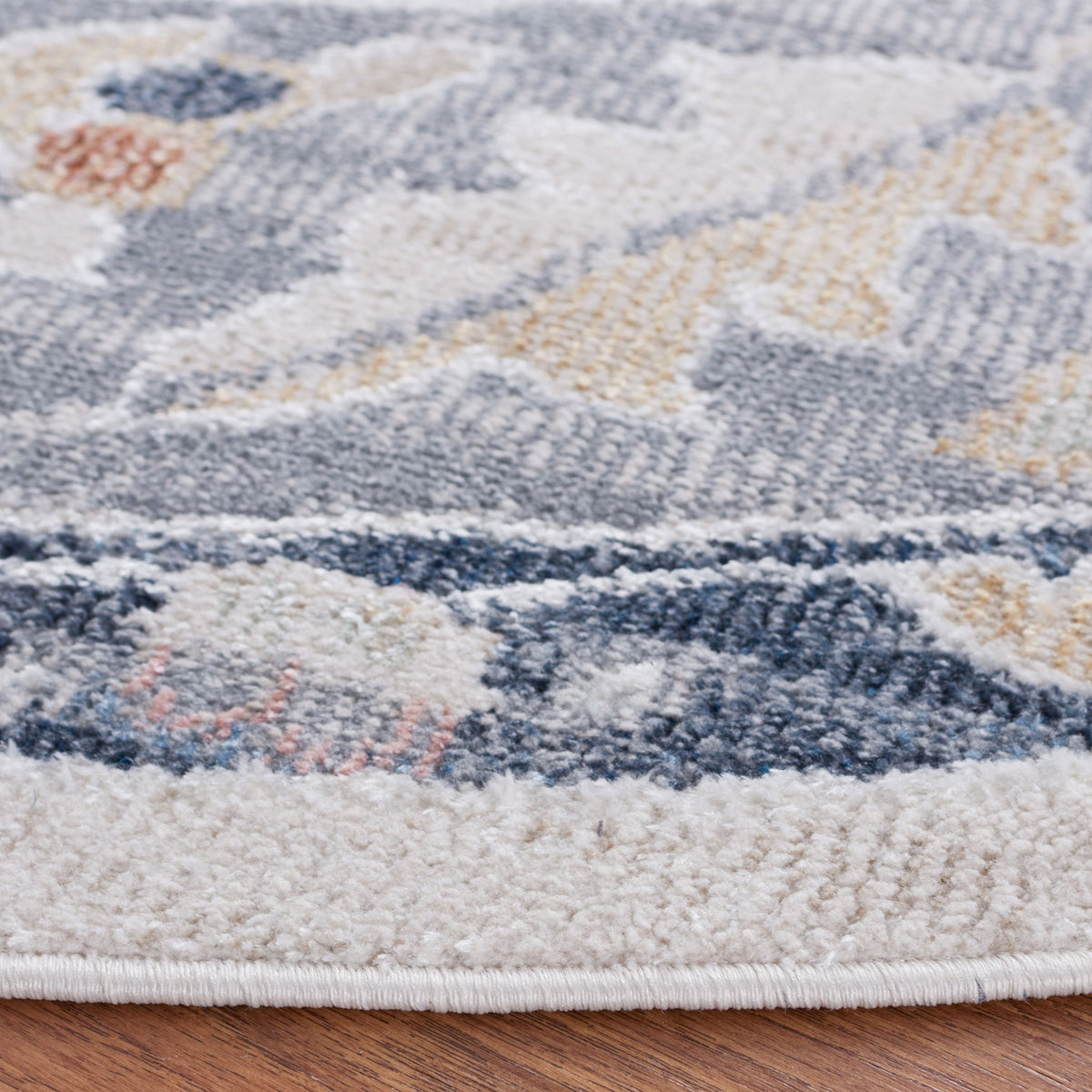 Low-pile texture and neatly bound edge highlight the beige and navy motif || BLR204B-7R || detail_room