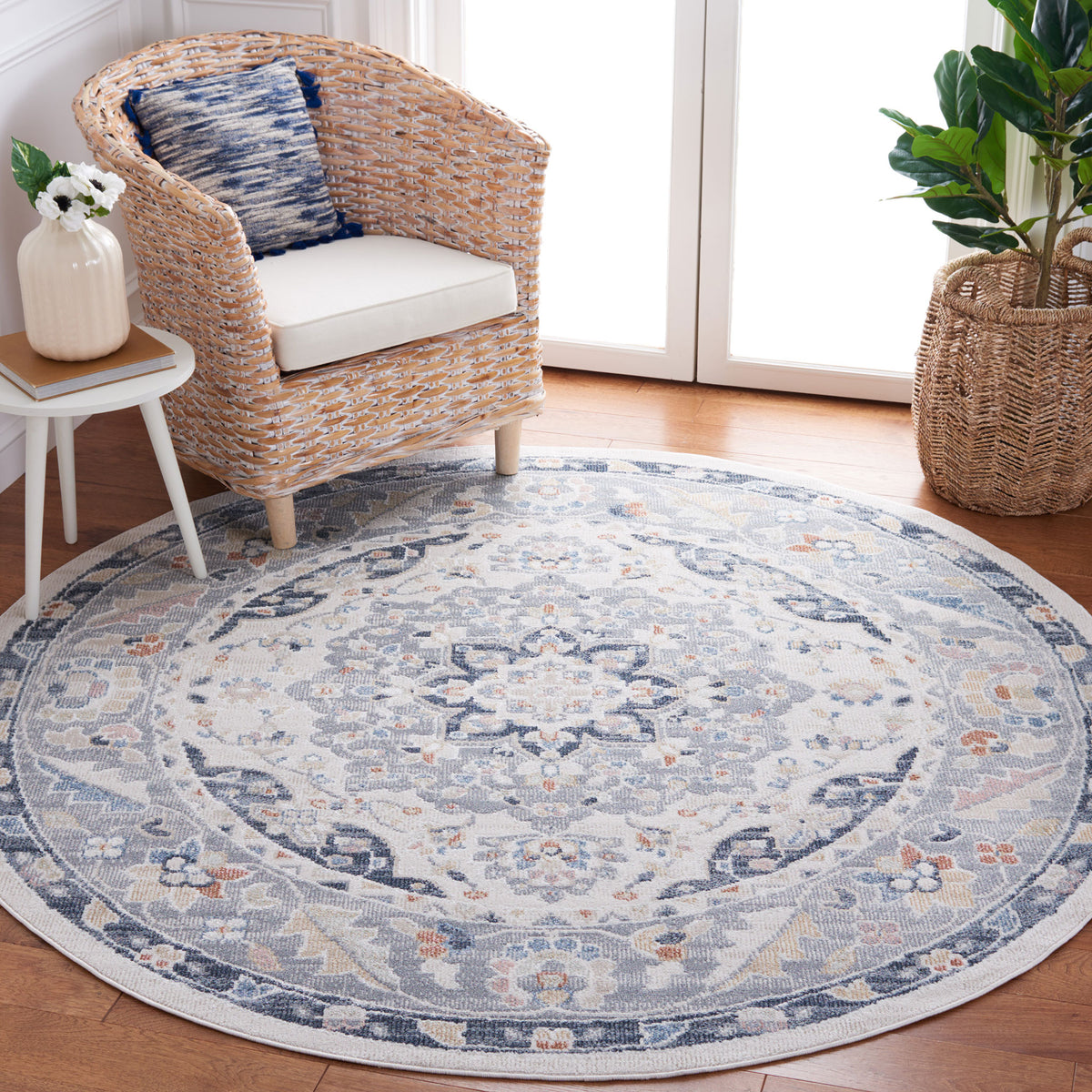 Round rug anchors the space with a beige and navy medallion and soft, lived-in look || BLR204B-7R || top_room