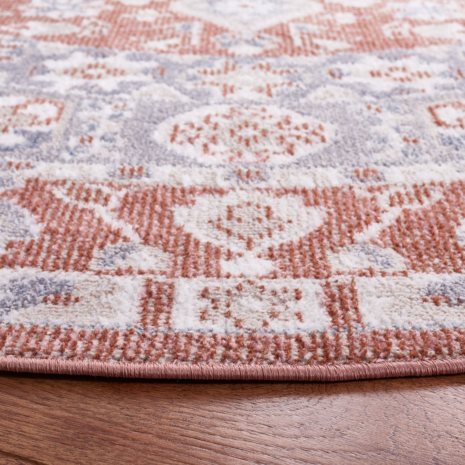 Low-profile pile and neatly serged edge highlight the rug's rose and gray pattern and tight weave || BLR206U-7R || detail_room