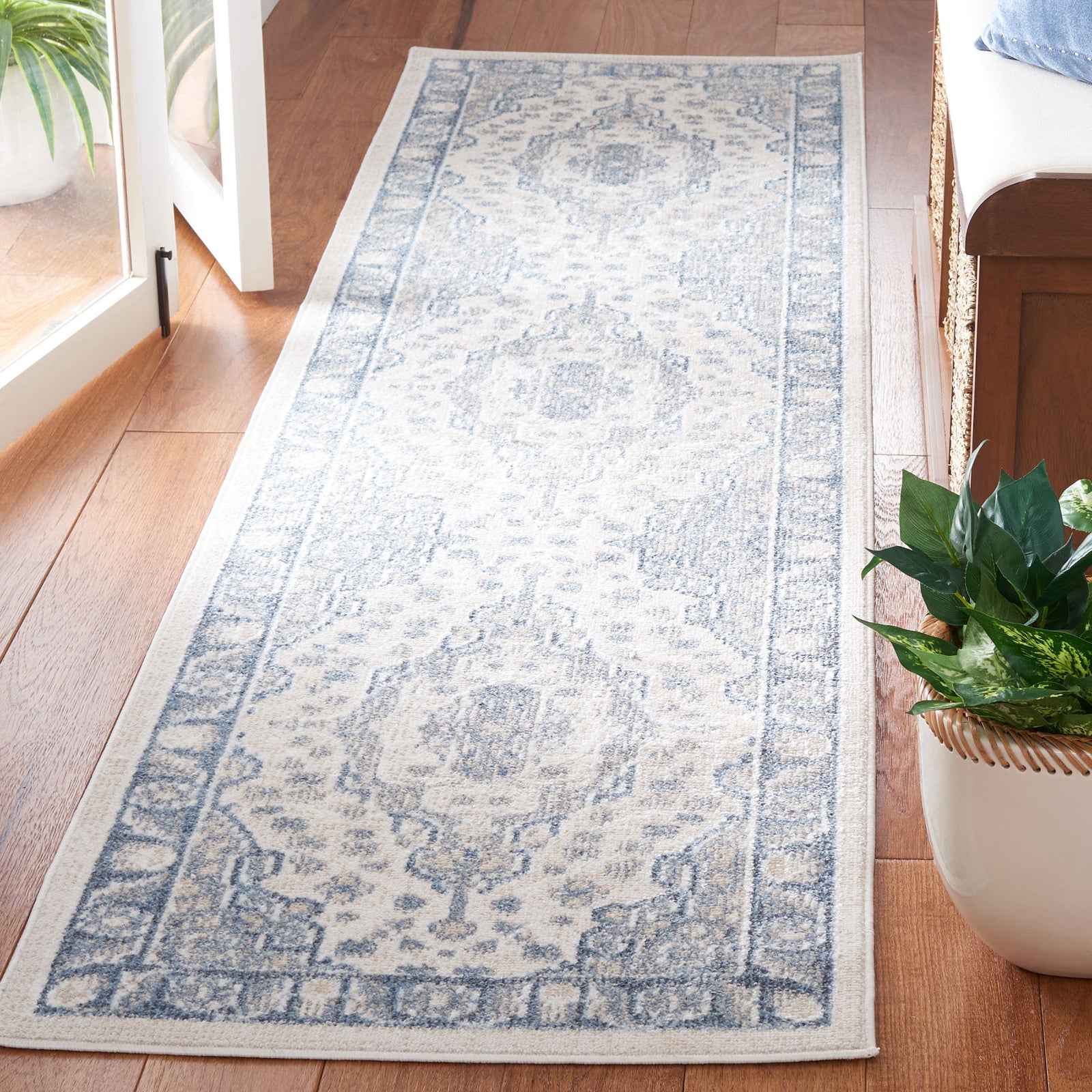 Distressed beige and blue medallion runner with ornate border and a slim profile || BLR208B-28 || front_angle_room