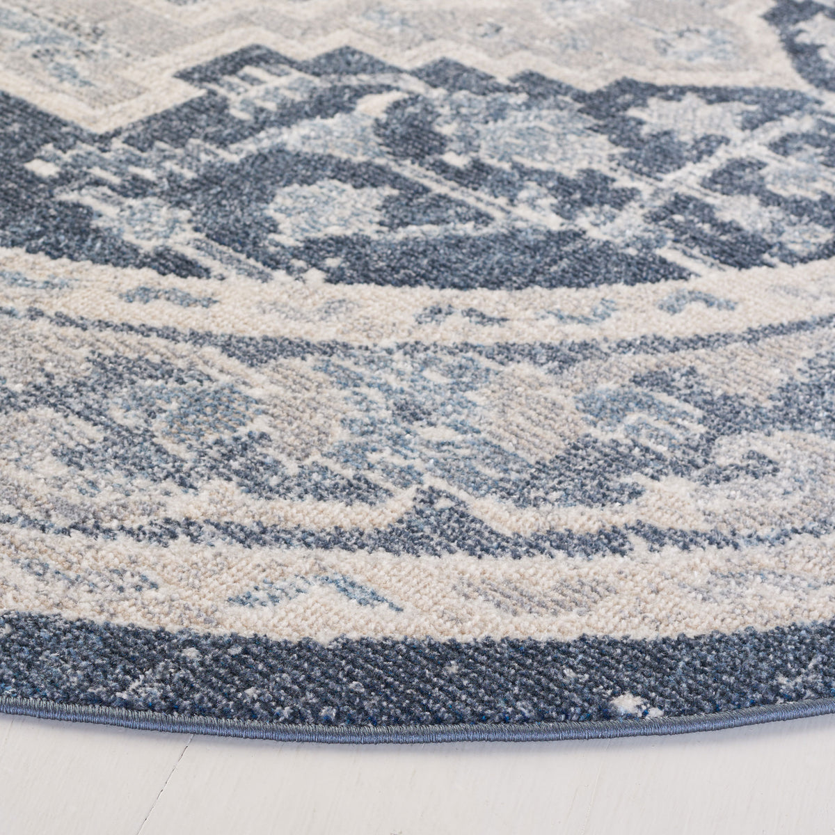 Textured low-pile fibers and neatly bound edge showcase the beige and navy pattern of this washable rug. || BLR210B-7R || detail_studio