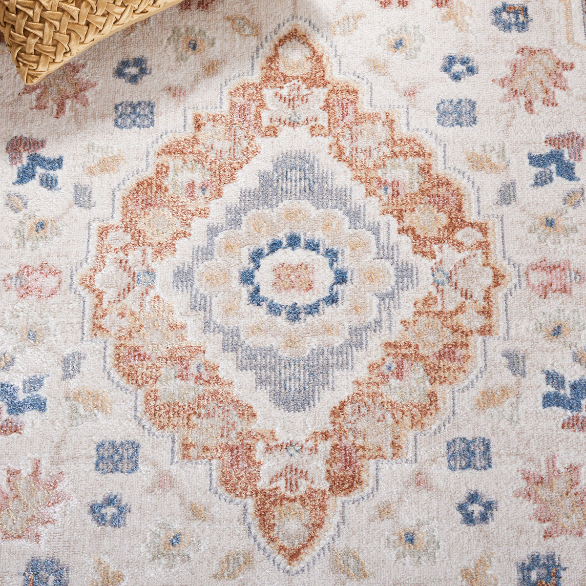 Warm rust and blue medallion pattern adds vintage character to neutral beige tones || BLR214B-5 || detail_room
