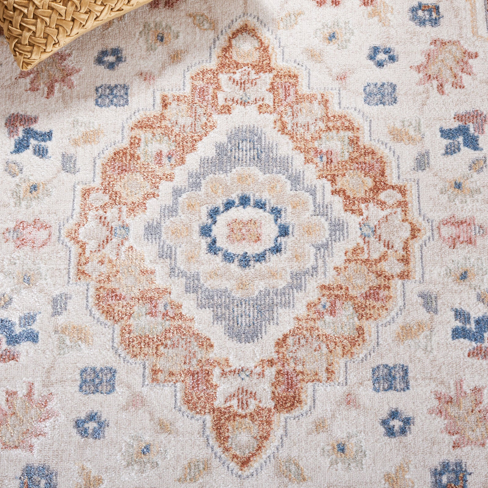 Warm rust and blue medallion pattern adds vintage character to neutral beige tones || BLR214B-5 || detail_room