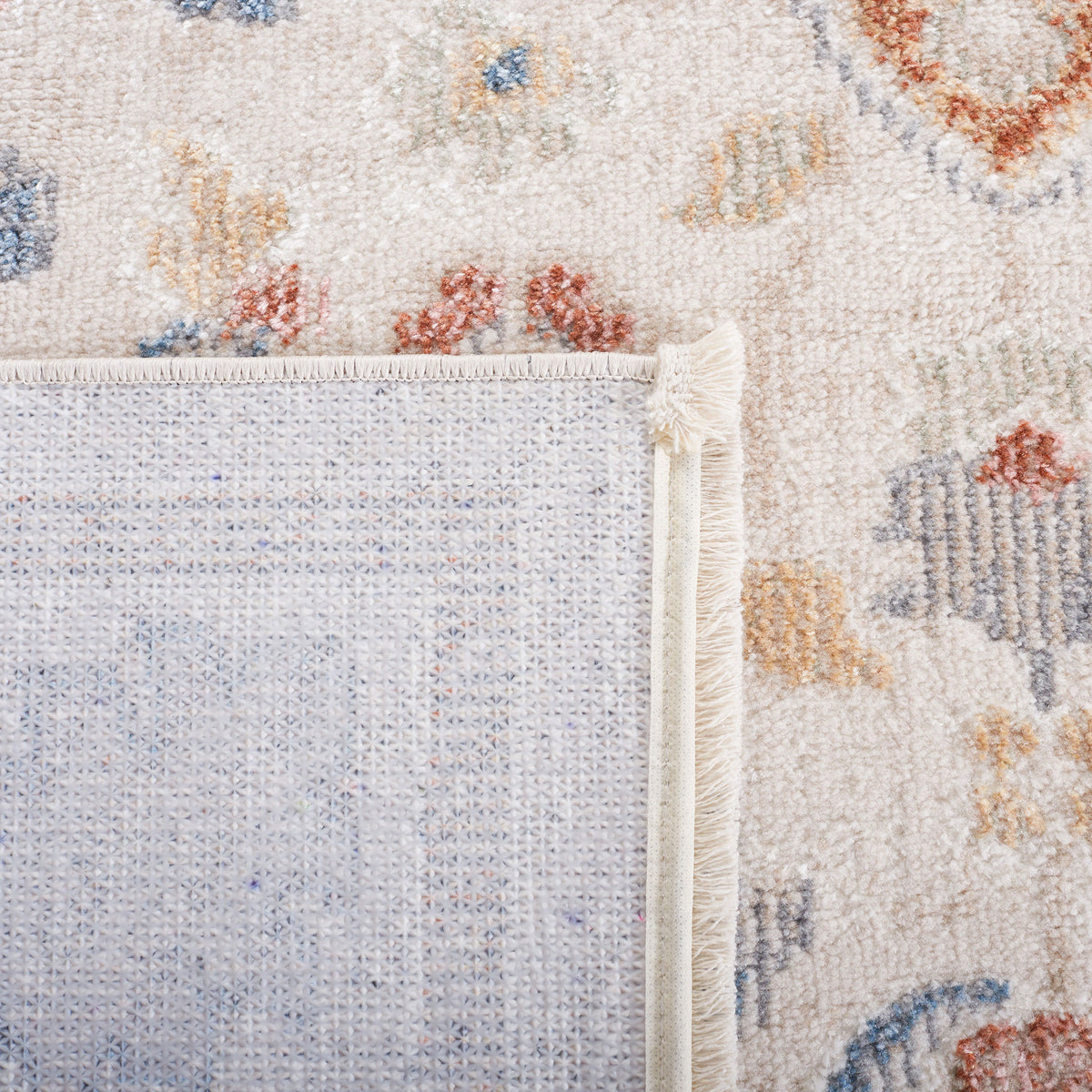 Turned corner displays the rug's secure binding and textured backing || BLR214B-5 || backing_room