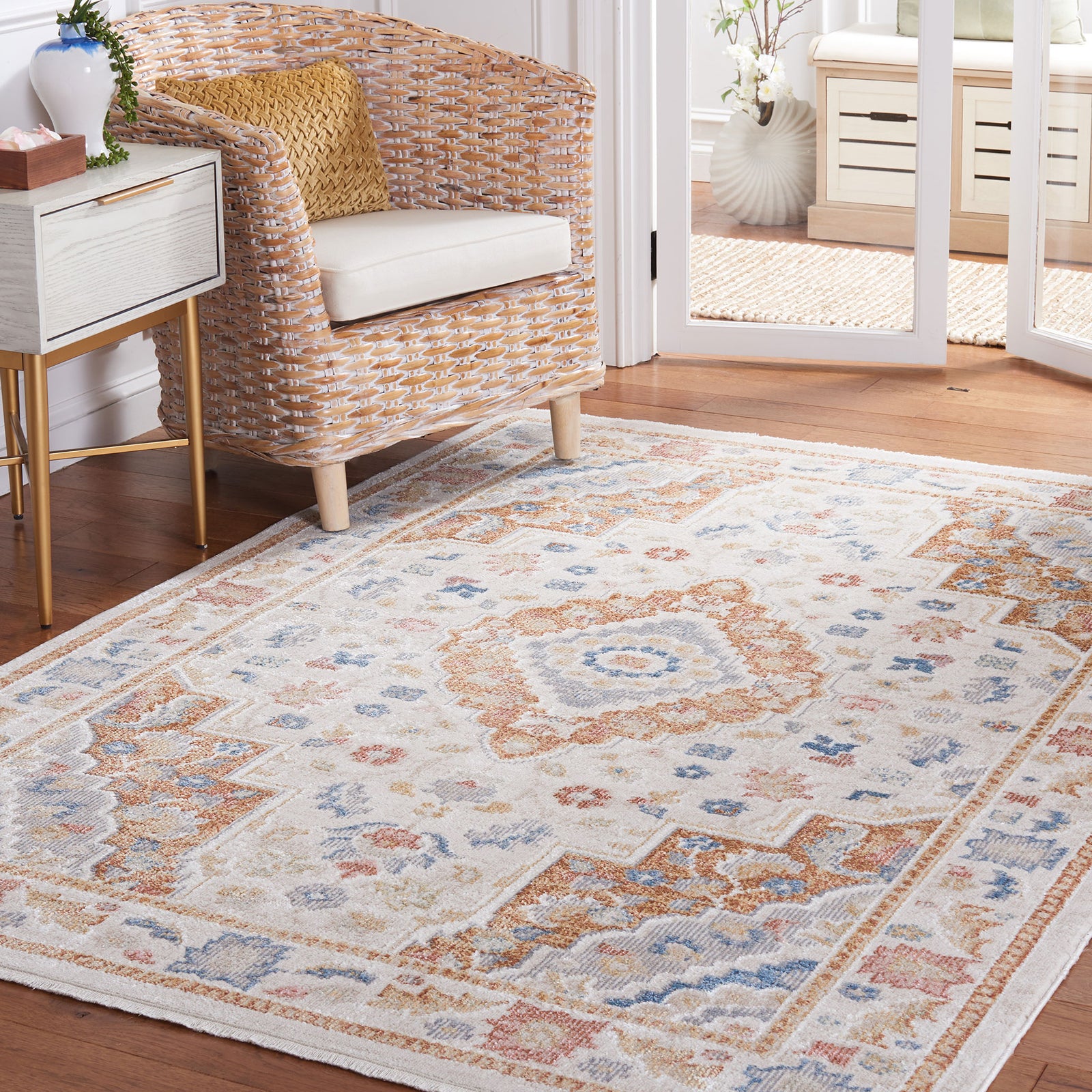 Beige and rust medallion rug grounds a bright room with soft texture and timeless pattern || BLR214B-5 || front_angle_room