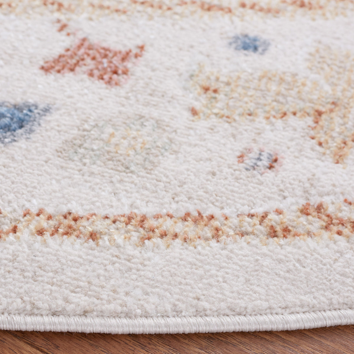 Soft low-pile edge with neat binding and a speckled beige, rust, and blue pattern || BLR214B-7R || detail_room