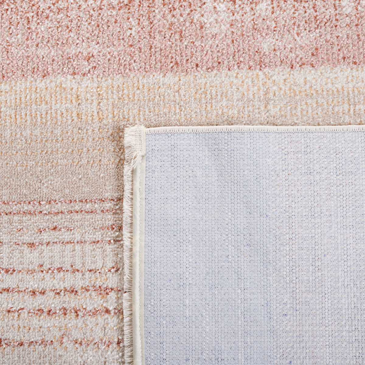 Corner flipped to show the backing and tidy edge finish in soft beige, rust, and blue || BLR216B-5 || backing_room