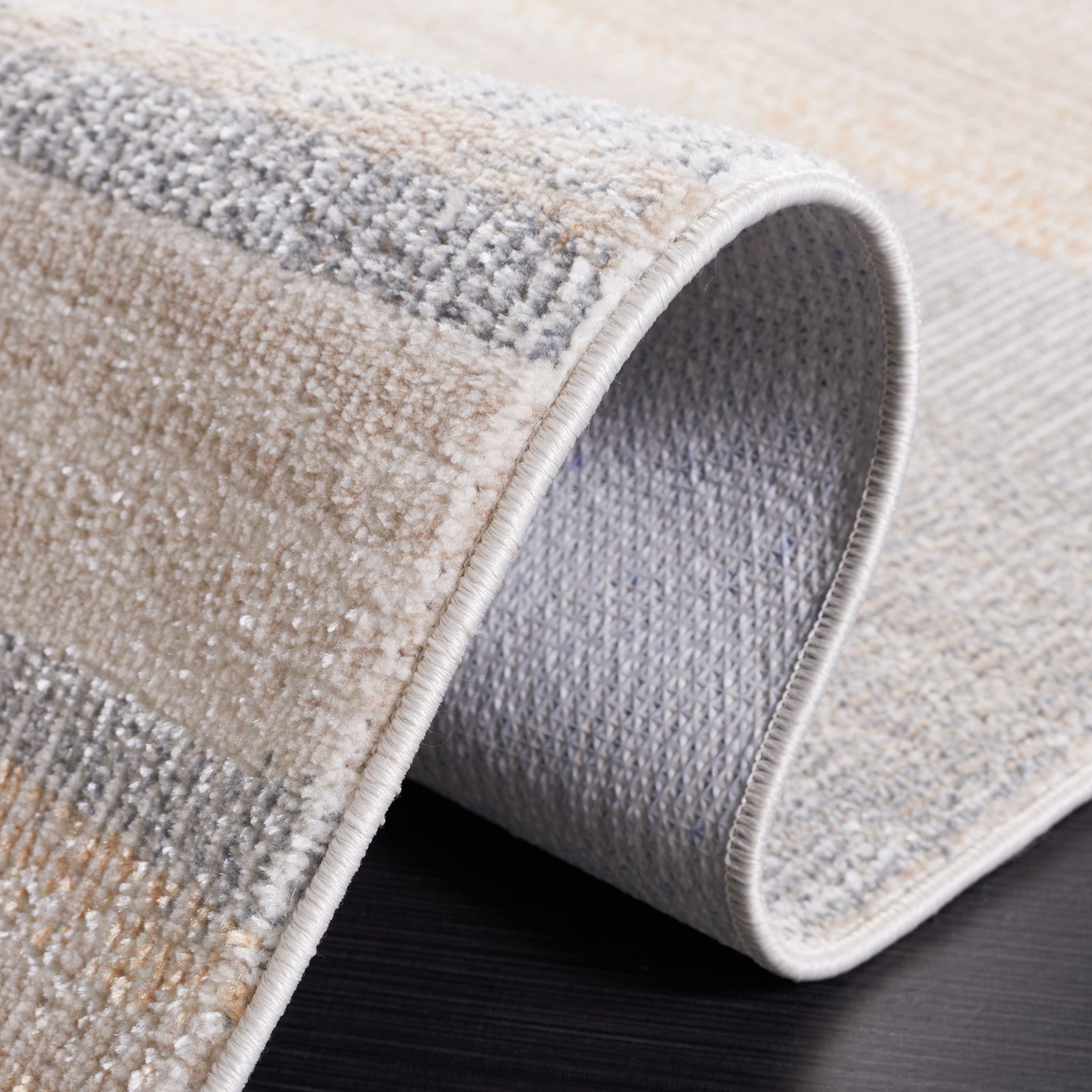 Fold reveals the flexible backing and neatly serged edge. || BLR216F-5 || backing_studio