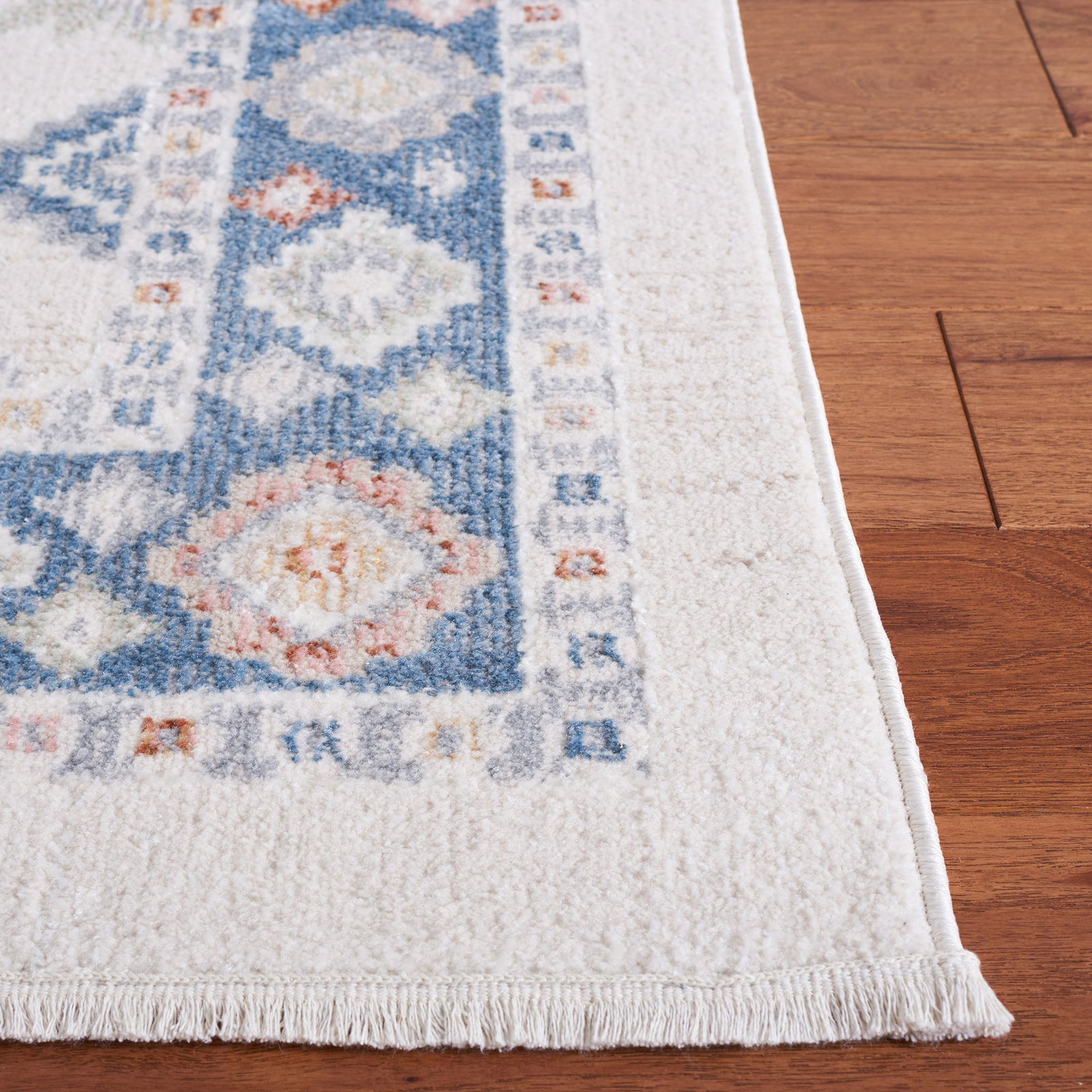 Border detail shows low-pile texture and fringed edge in soft beige and blue || BLR218B-5 || detail_room