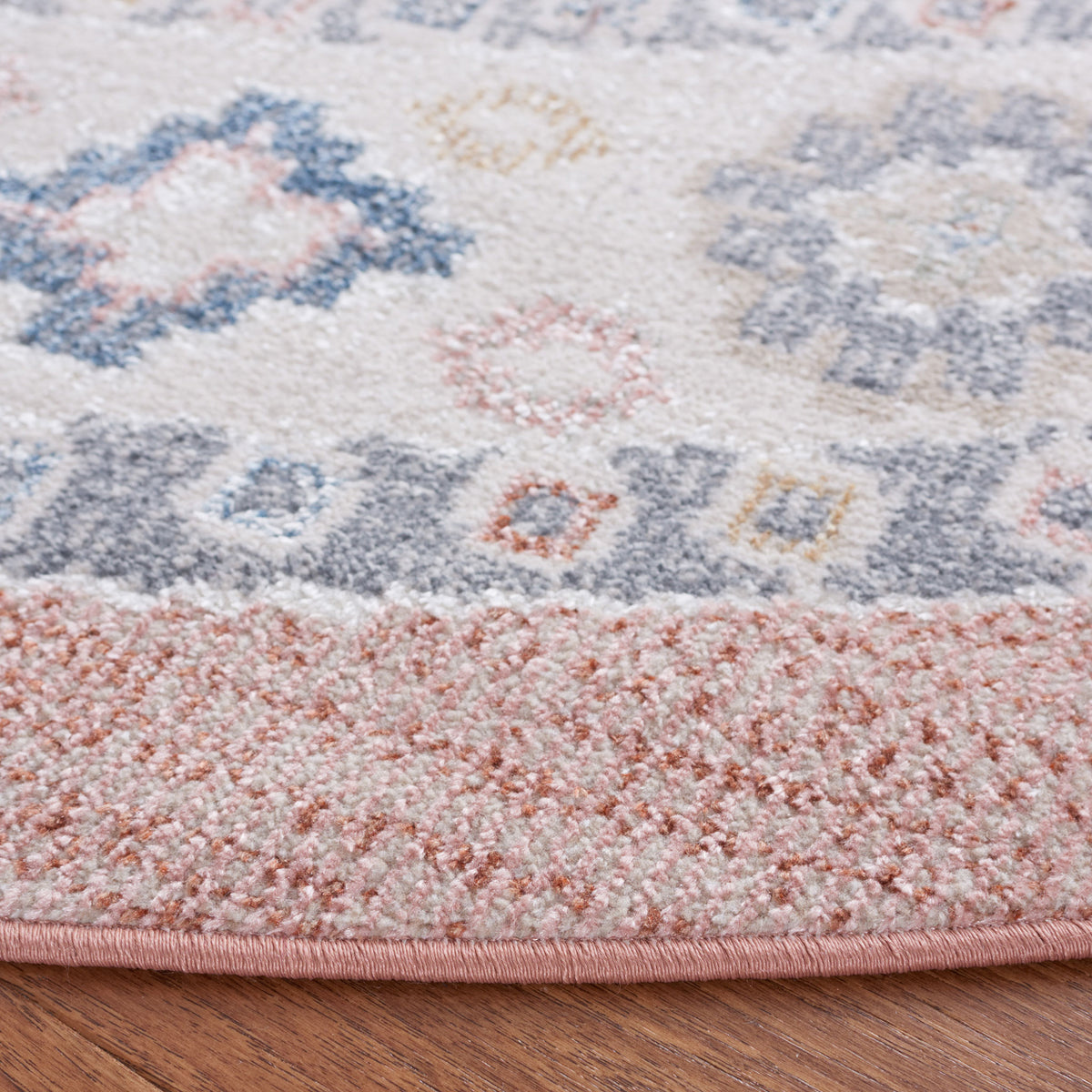 Soft low-pile texture and neatly bound edge in rose and blue highlight its durable, washable weave || BLR218U-7R || detail_room