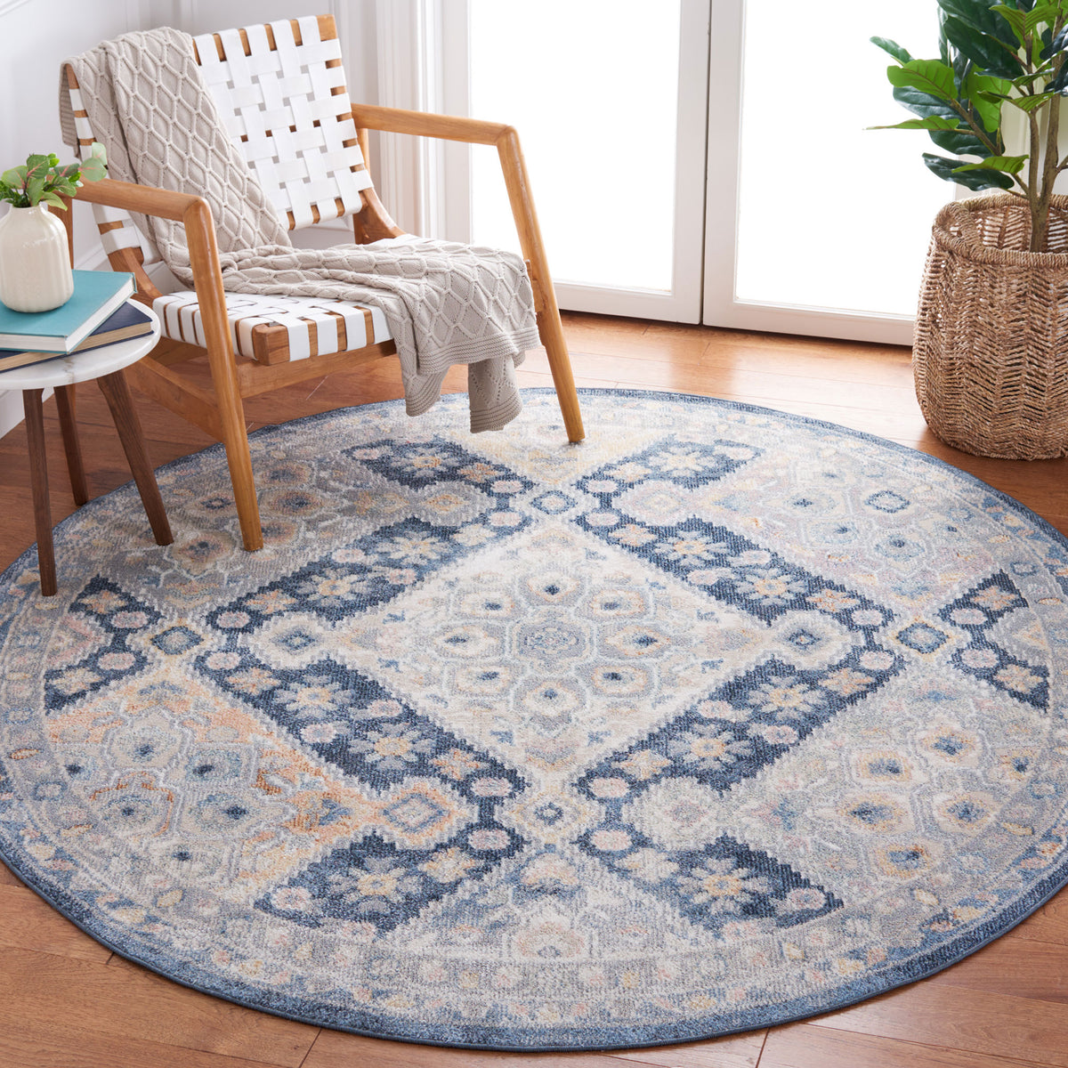 Vintage-inspired round rug in navy and gray adds softness and pattern to a bright reading nook || BLR220F-7R || top_angle_room