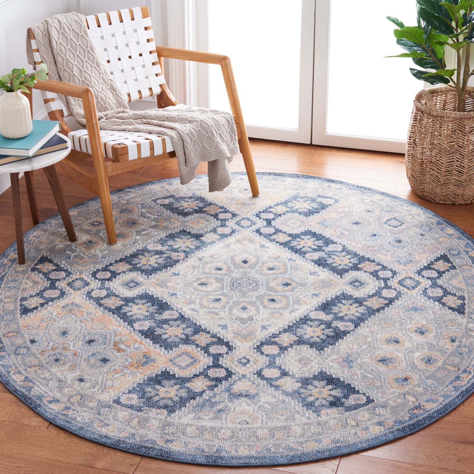 Vintage-inspired round rug in navy and gray adds softness and pattern to a bright reading nook || BLR220F-7R || top_angle_room