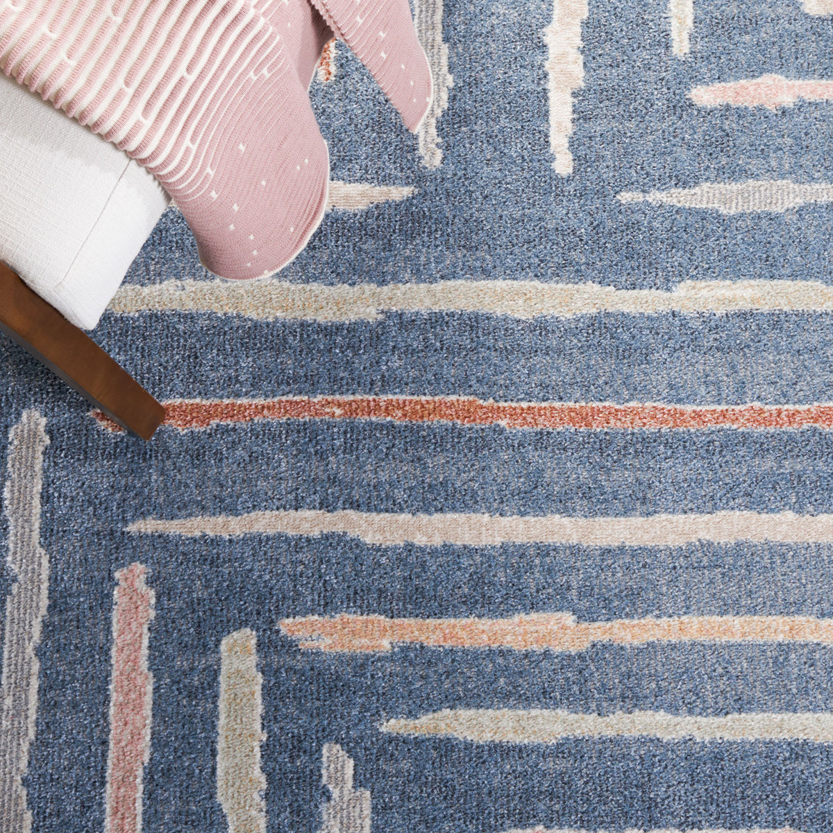 Blue rug with modern linear pattern alongside a wood chair and blush throw || BLR222M-5 || detail_room