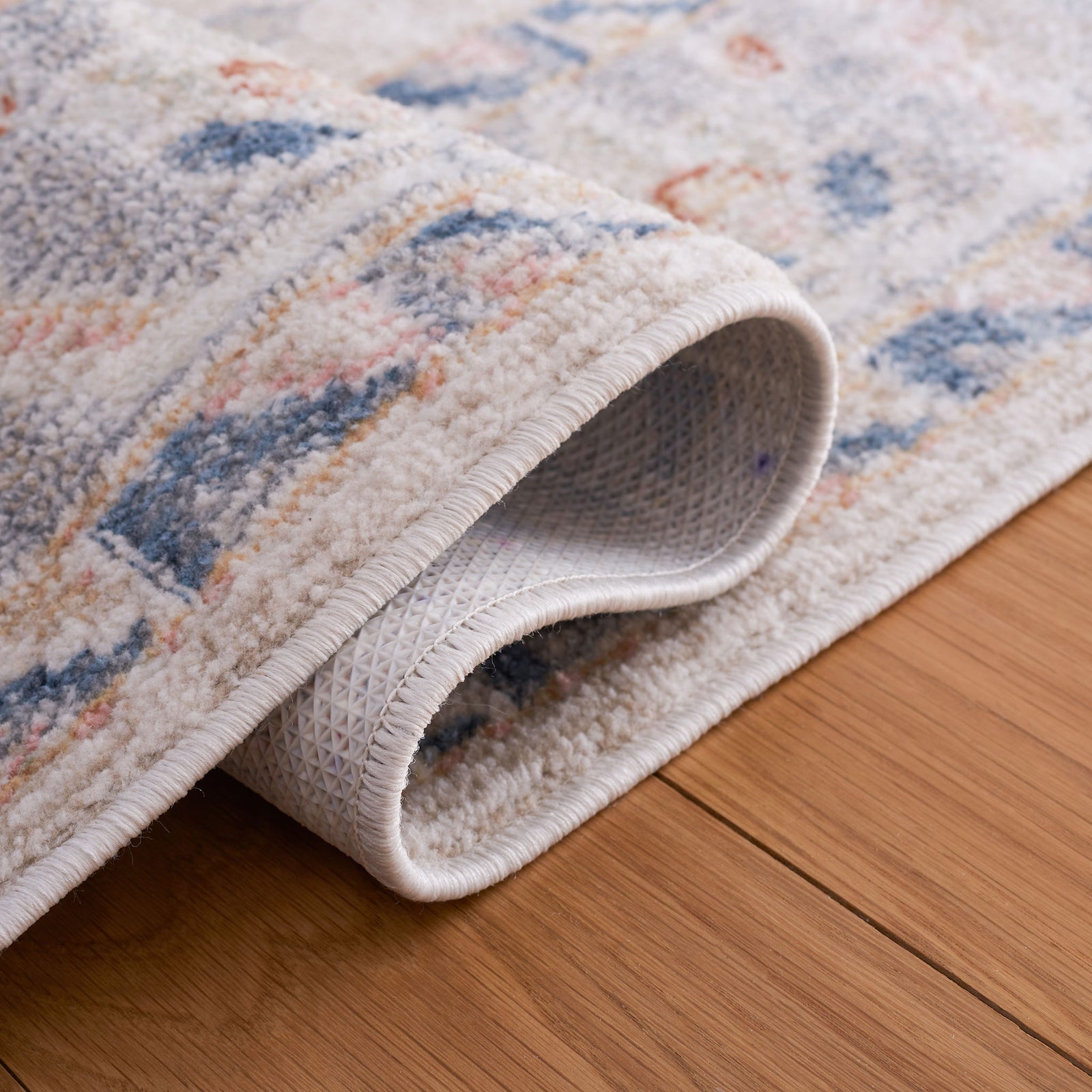 Textured backing and supple pile help the rug stay flat and make upkeep easy. || BLR232B-5 || backing_room