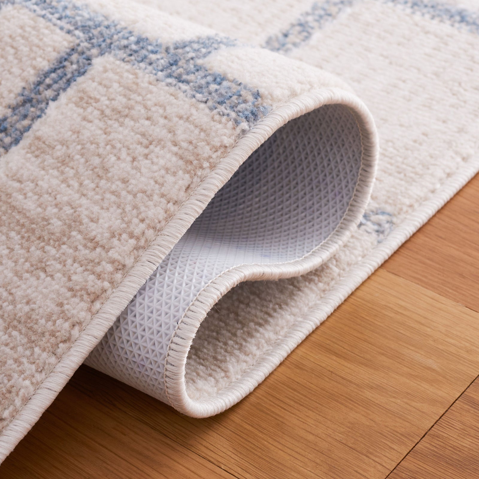 Folded edge reveals textured backing and soft beige and gray pile || BLR238B-5 || backing_room