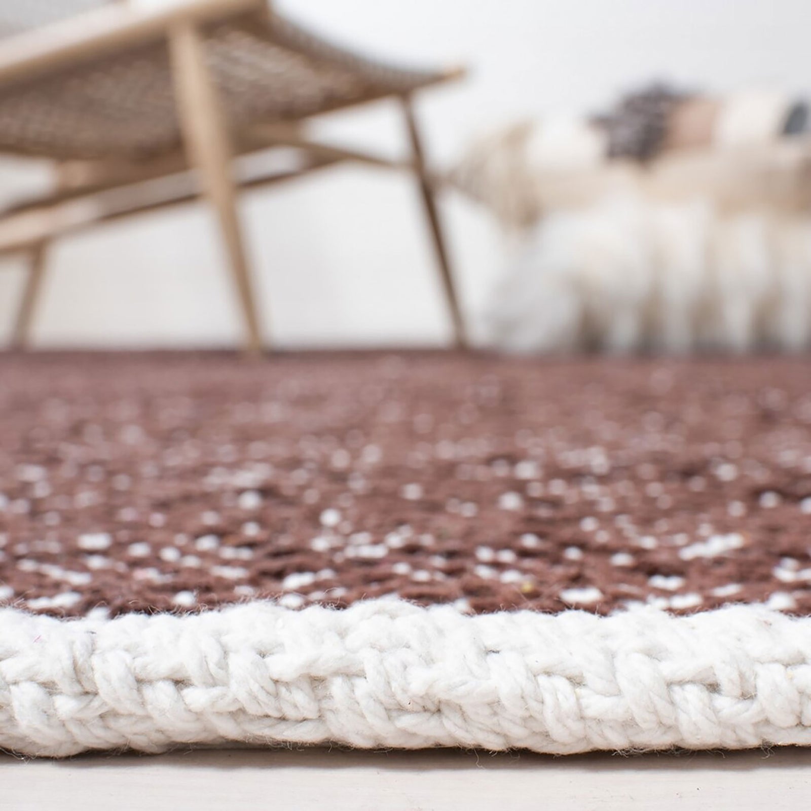 Close-up of brown and ivory woven rug with a textured surface and thick ivory edge || BOS680A-5 || detail_room
