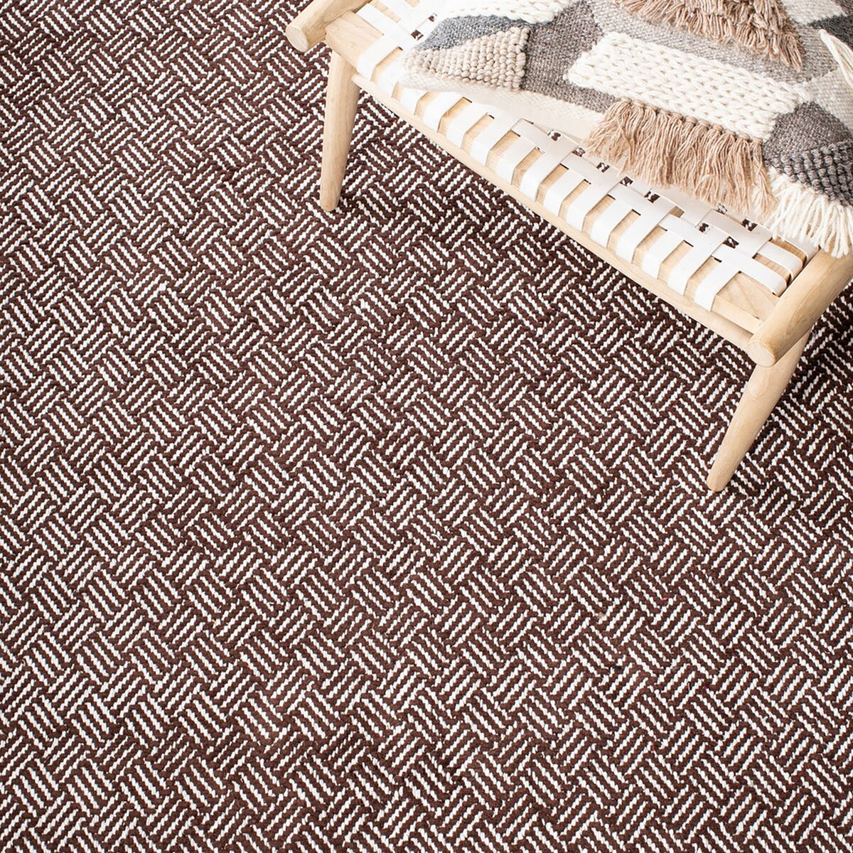 Brown and ivory herringbone rug shown beneath a light wood accent chair || BOS680A-5 || detail_room
