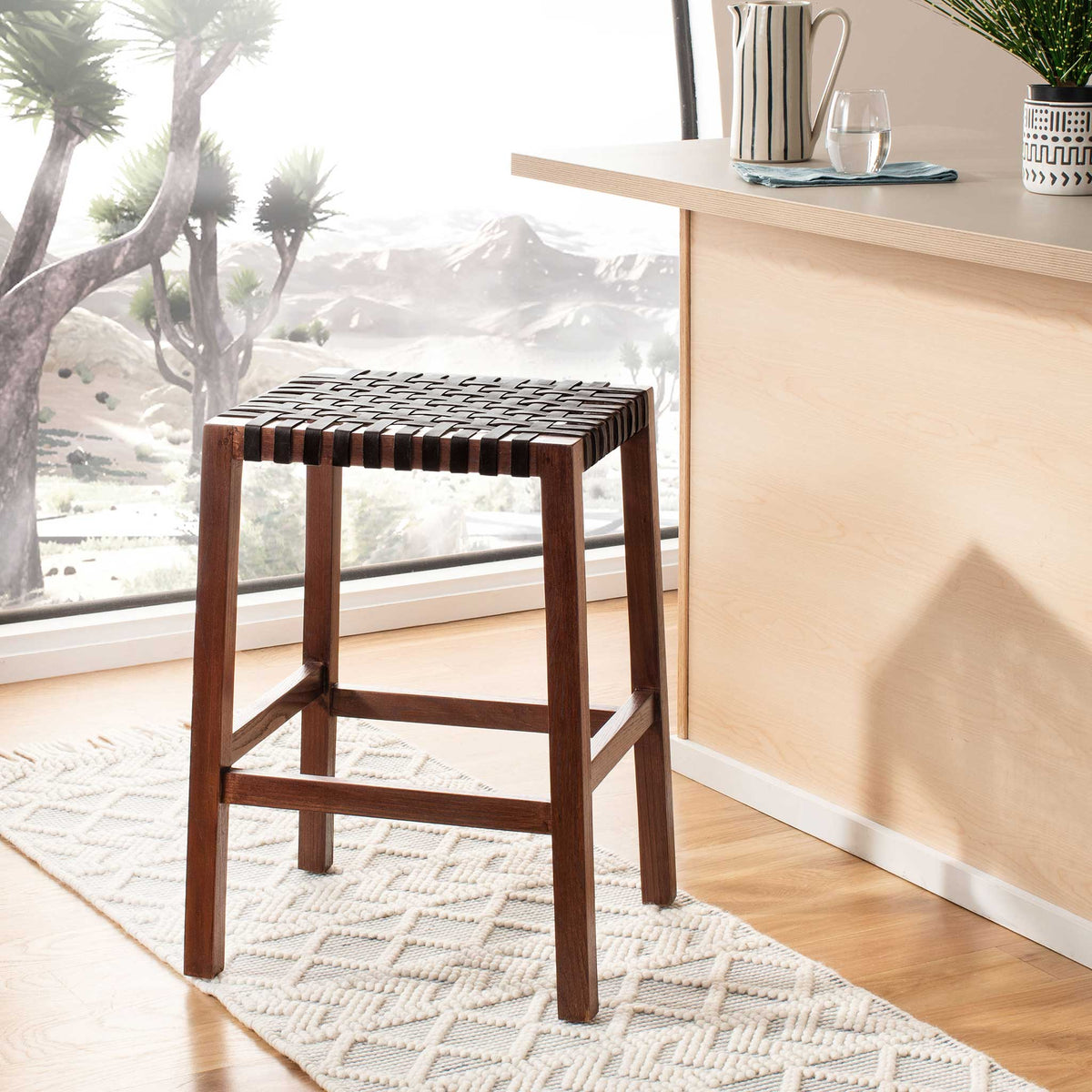 A warm brown frame and woven leather seat bring casual texture to a bright kitchen counter.