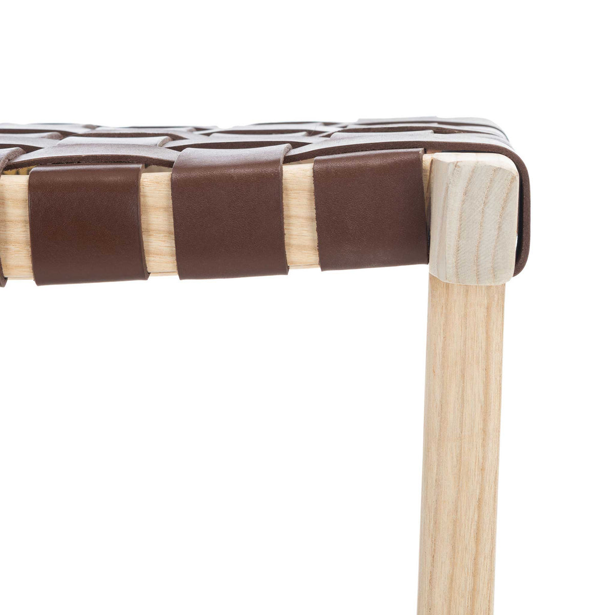 Rich cognac leather loops over the pale wood seat edge, showing the woven construction