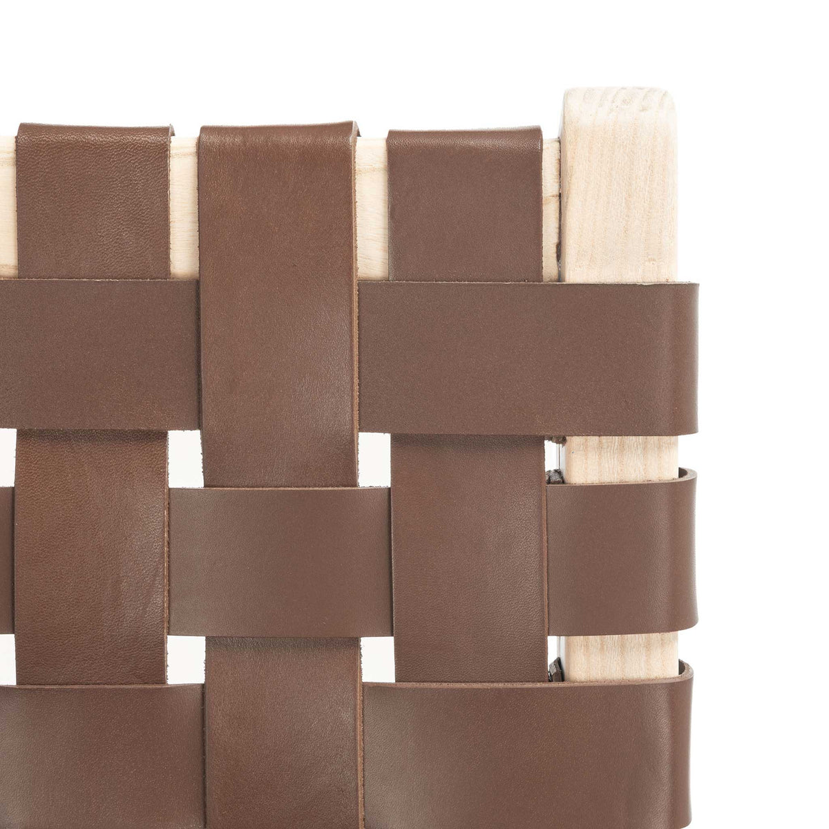 Broad cognac leather bands cross around the light wood backrest for a rich woven texture.