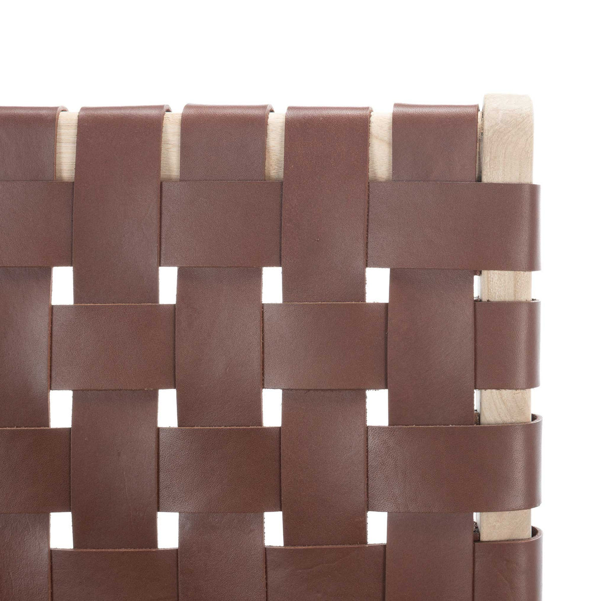 Smooth cognac leather strips interlace over pale wood for a warm, handcrafted look.