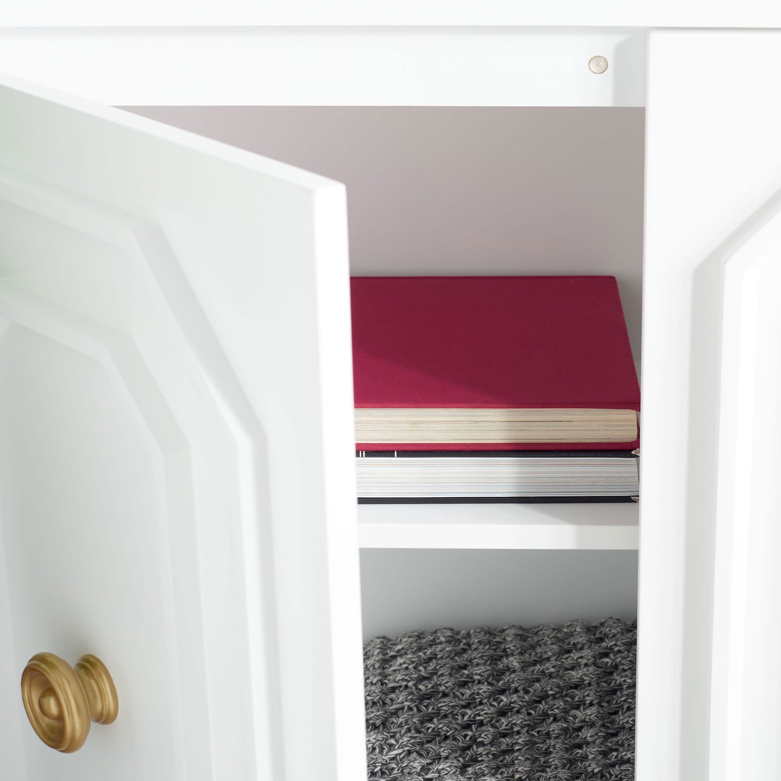 An adjustable interior shelf keeps books and other essentials organized behind the cabinet doors. || CHS5003A || storage_open_room