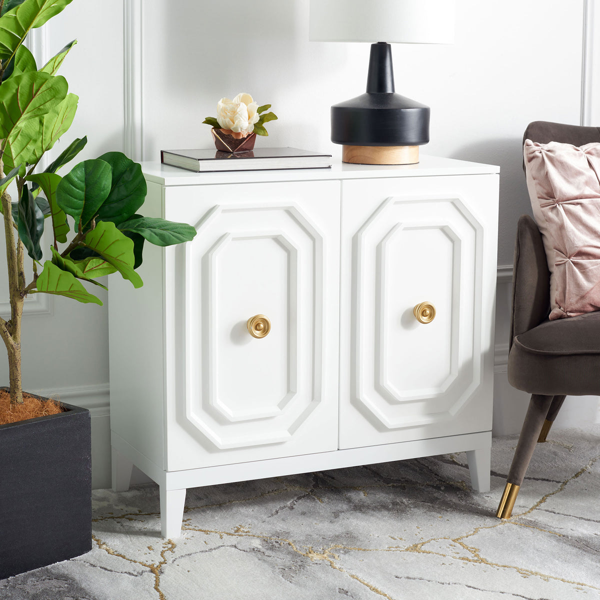 The white cabinet brings sculpted geometric details and warm gold-tone knobs to a living space. || CHS5003A || front_angle_room
