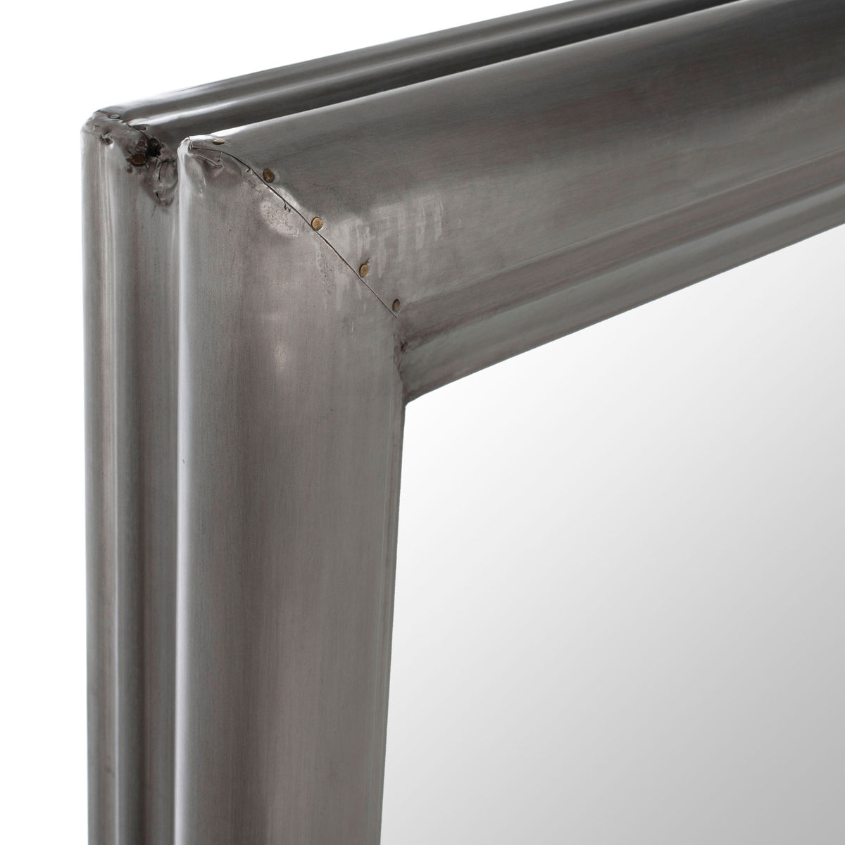 A softly brushed silver finish highlights the mirror frame's mitered corner and layered profile.