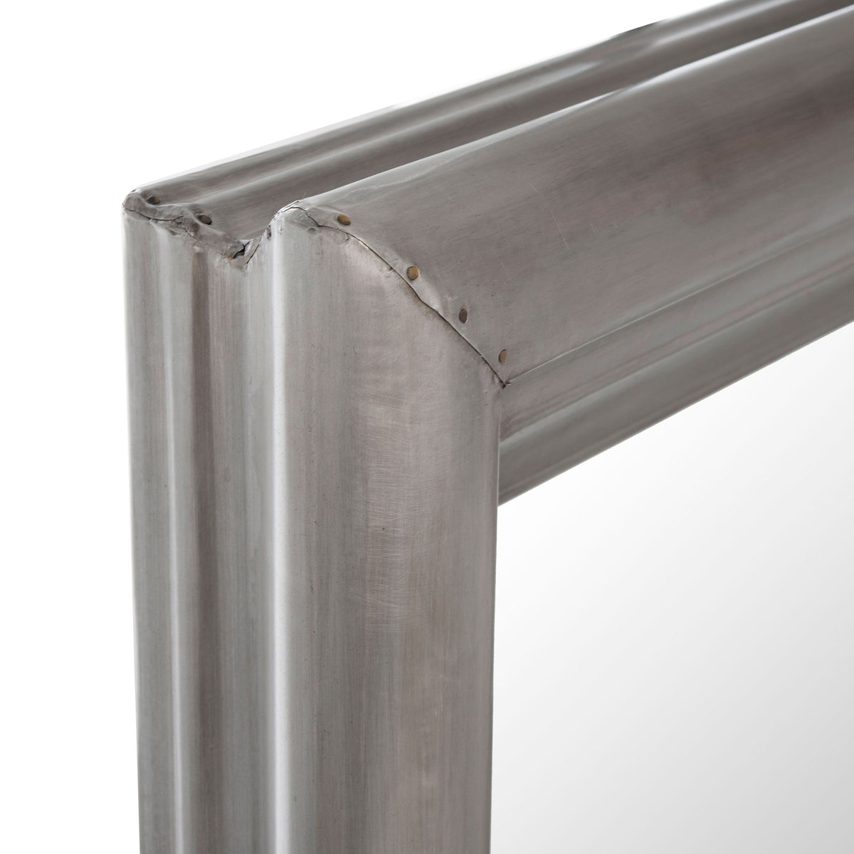 Gently brushed silver metal accentuates the mirror frame's mitered corner and rounded trim. || CMI2002B || detail_studio