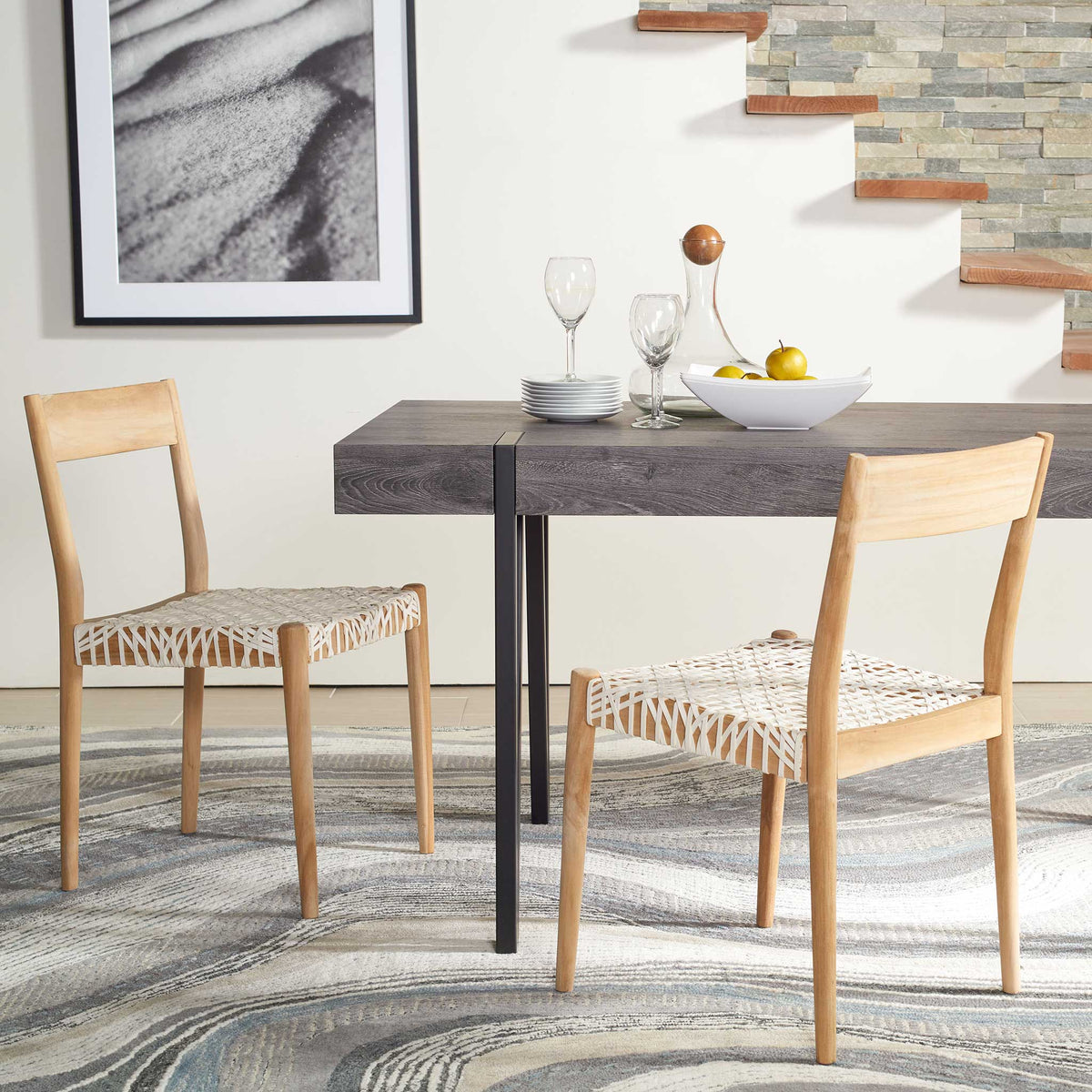 White woven leather and warm wood create a relaxed dining setup around the table