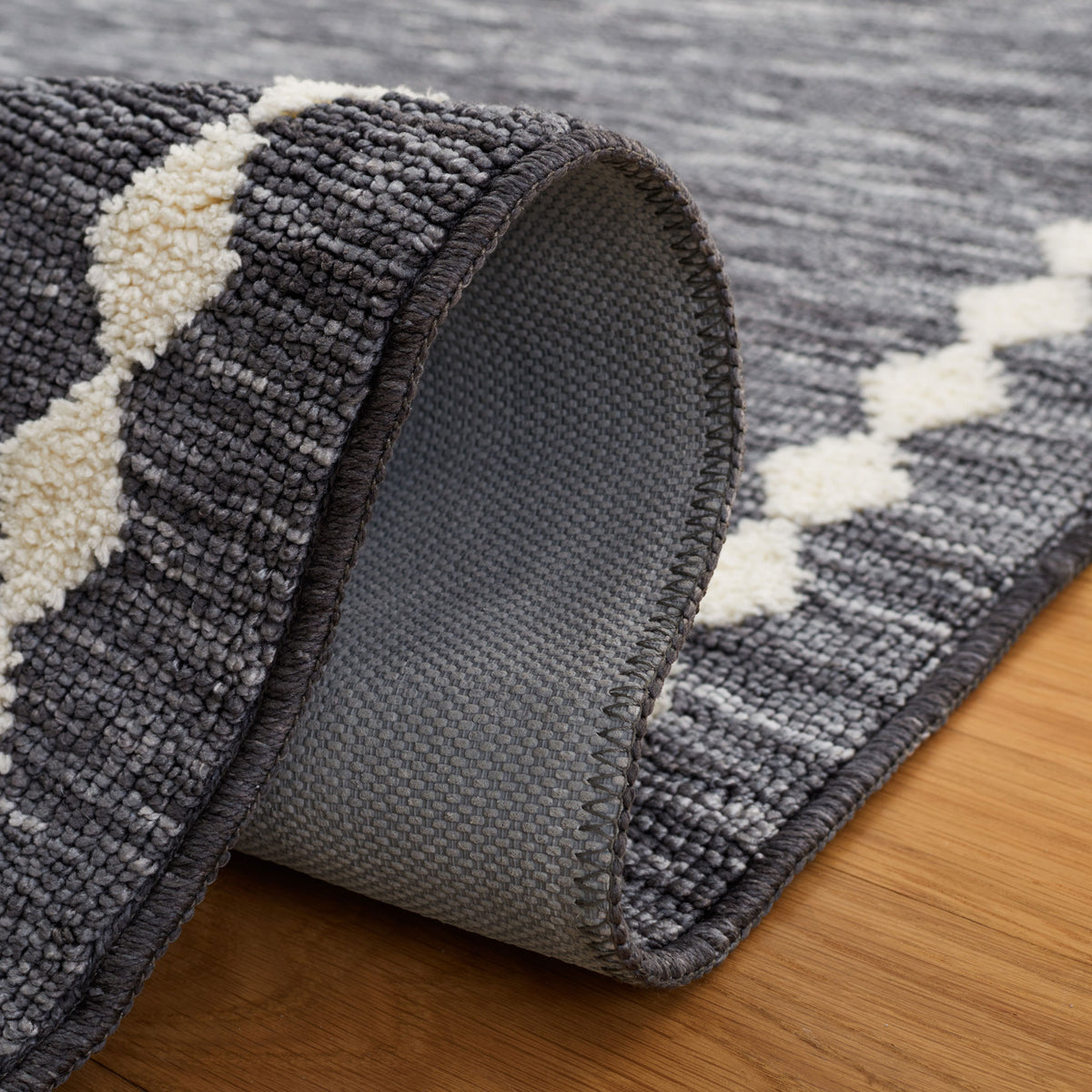 Flexible rug drapes smoothly to reveal its sturdy woven backing and clean, finished edges || ECR110F-5 || backing_room