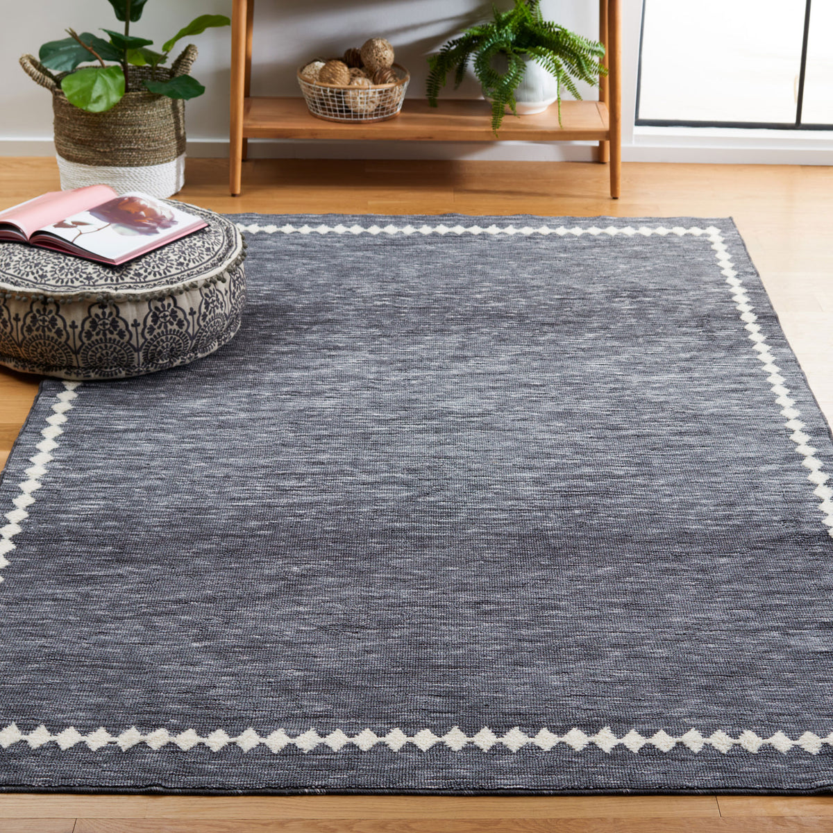 Bordered gray rug elevates a light-filled room with crisp ivory accents and a soft, easy-care feel || ECR110F-5 || top_angle_room