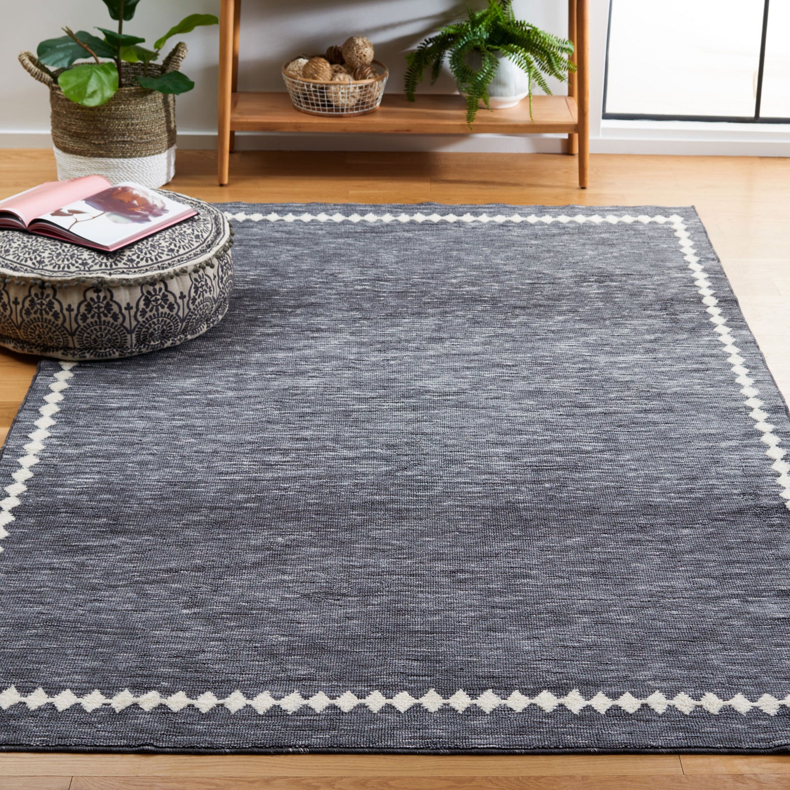 Bordered gray rug elevates a light-filled room with crisp ivory accents and a soft, easy-care feel || ECR110F-5 || top_angle_room