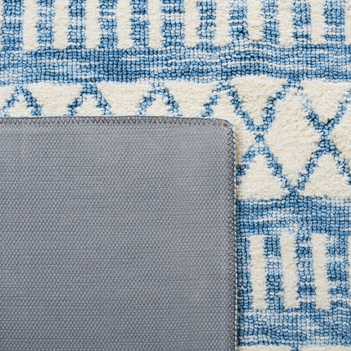 Backed corner displays latex underside and neatly serged edges against the patterned face || ECR114A-5 || backing_room