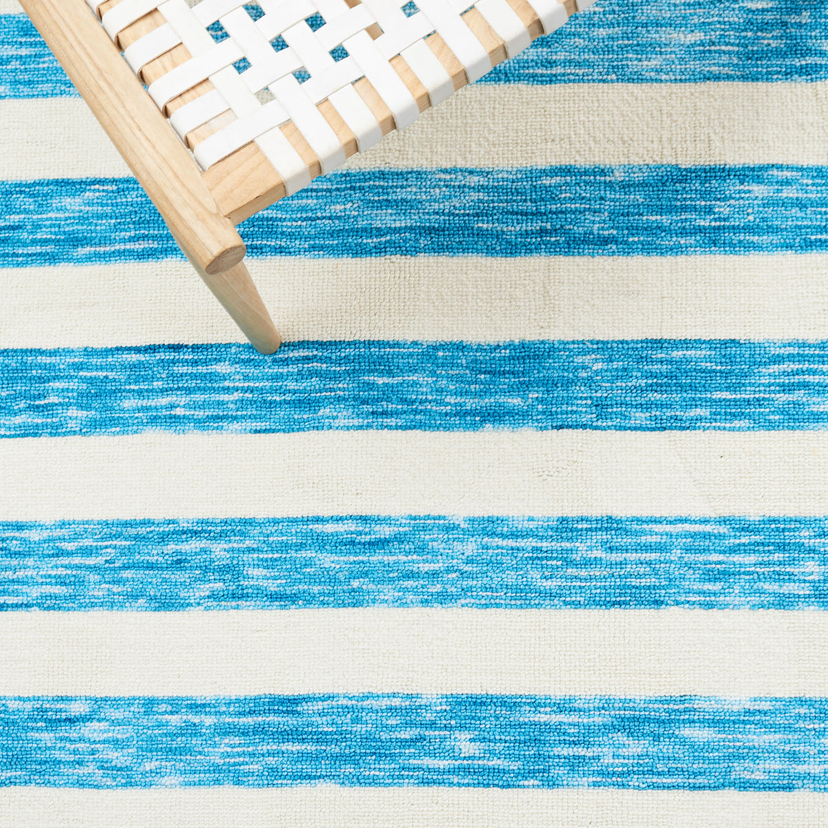 Vibrant sky-blue stripes pop against ivory, adding breezy style under modern seating || ECR115M-5 || detail_room