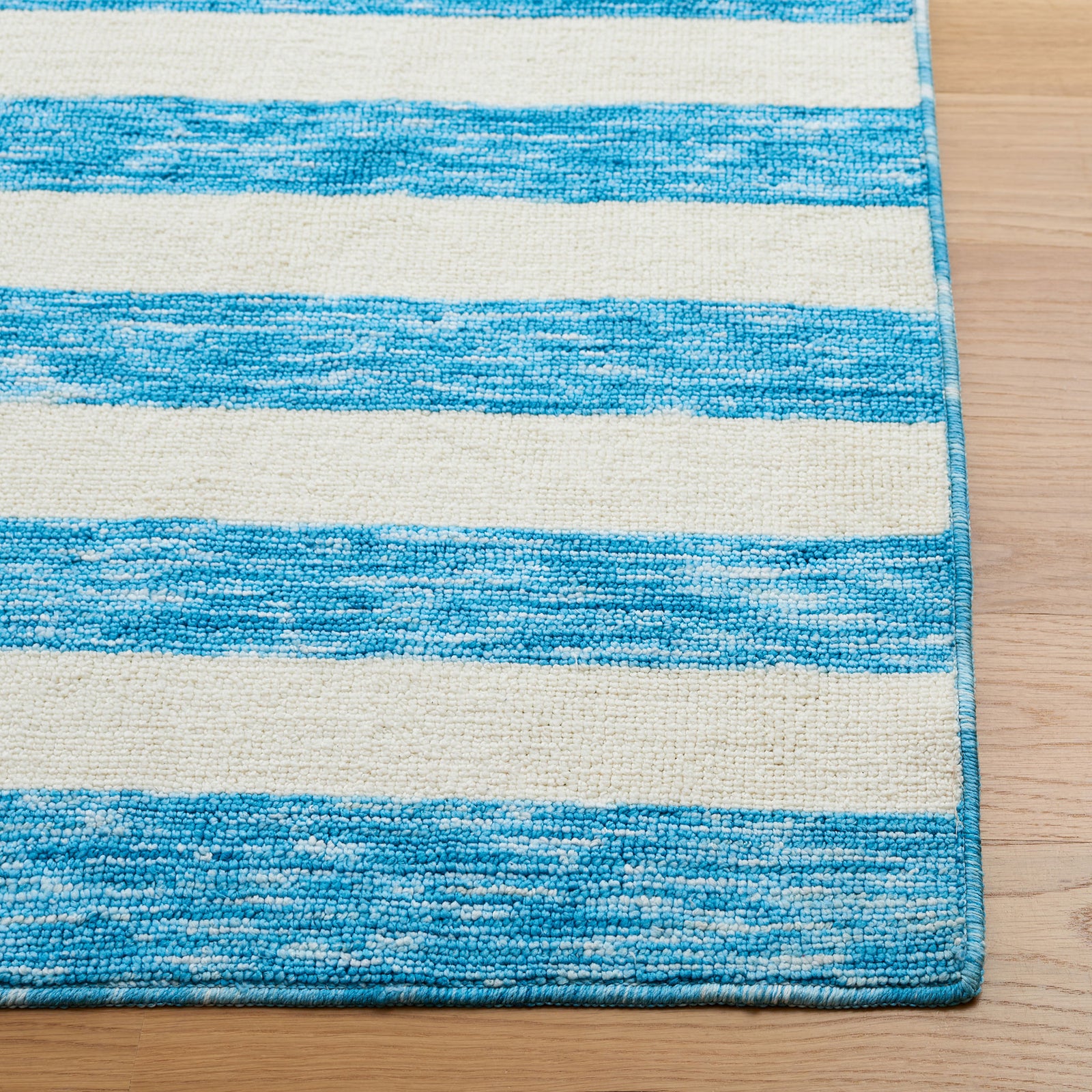 Blue and ivory striped area rug with crisp bands and heathered texture for a fresh coastal look || ECR115M-5 || top_studio