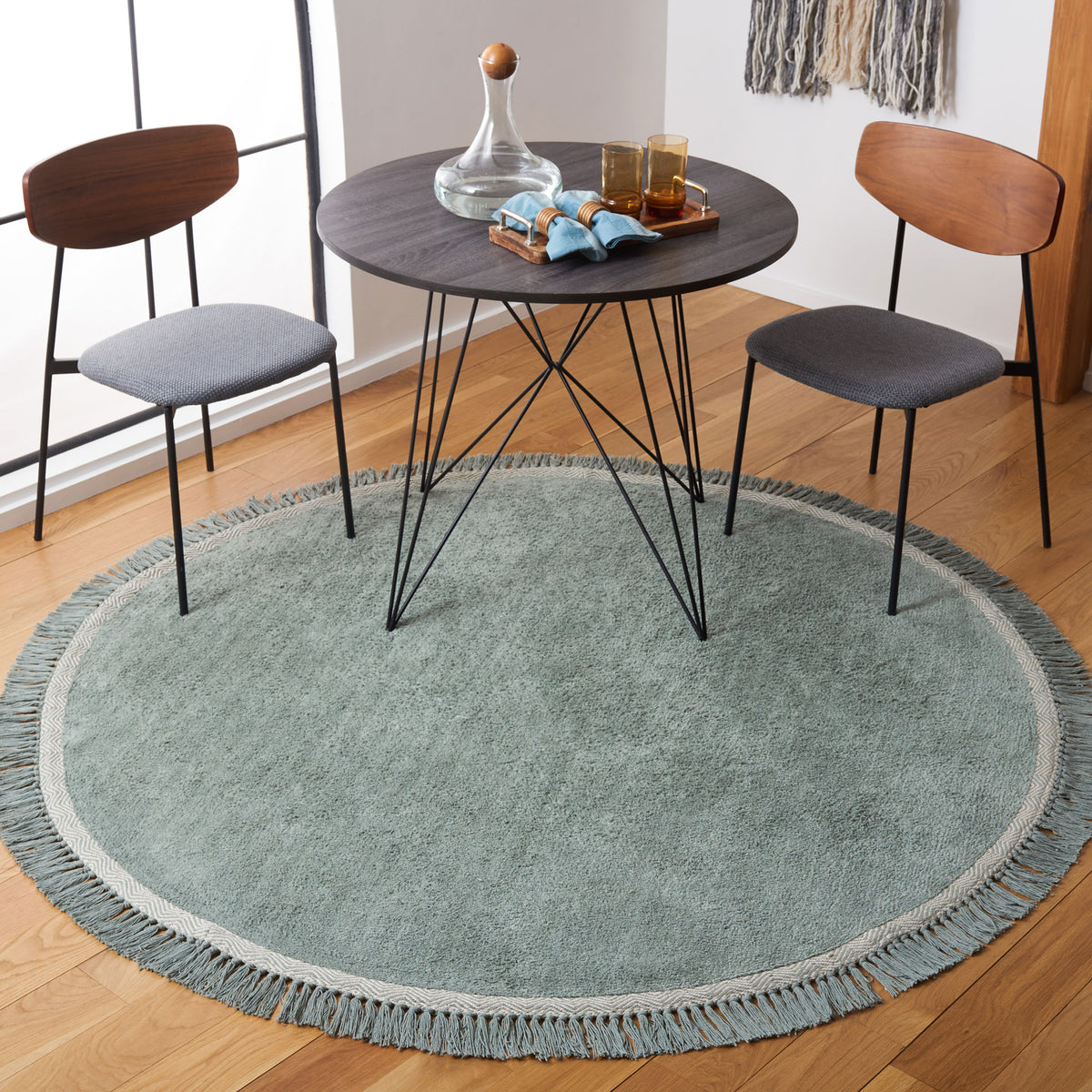 Teal round rug with ivory border and tassel fringe elevates your dining space || ECR202J-6R || top_room