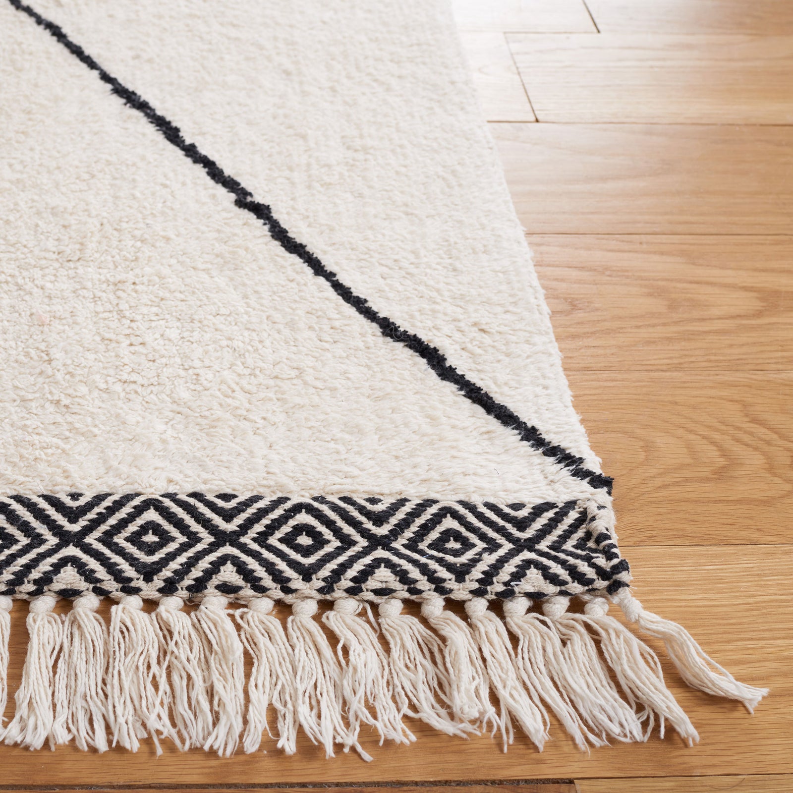 Fringed edge and patterned border with crisp black lines on plush ivory pile || ECR210A-5 || corner_room
