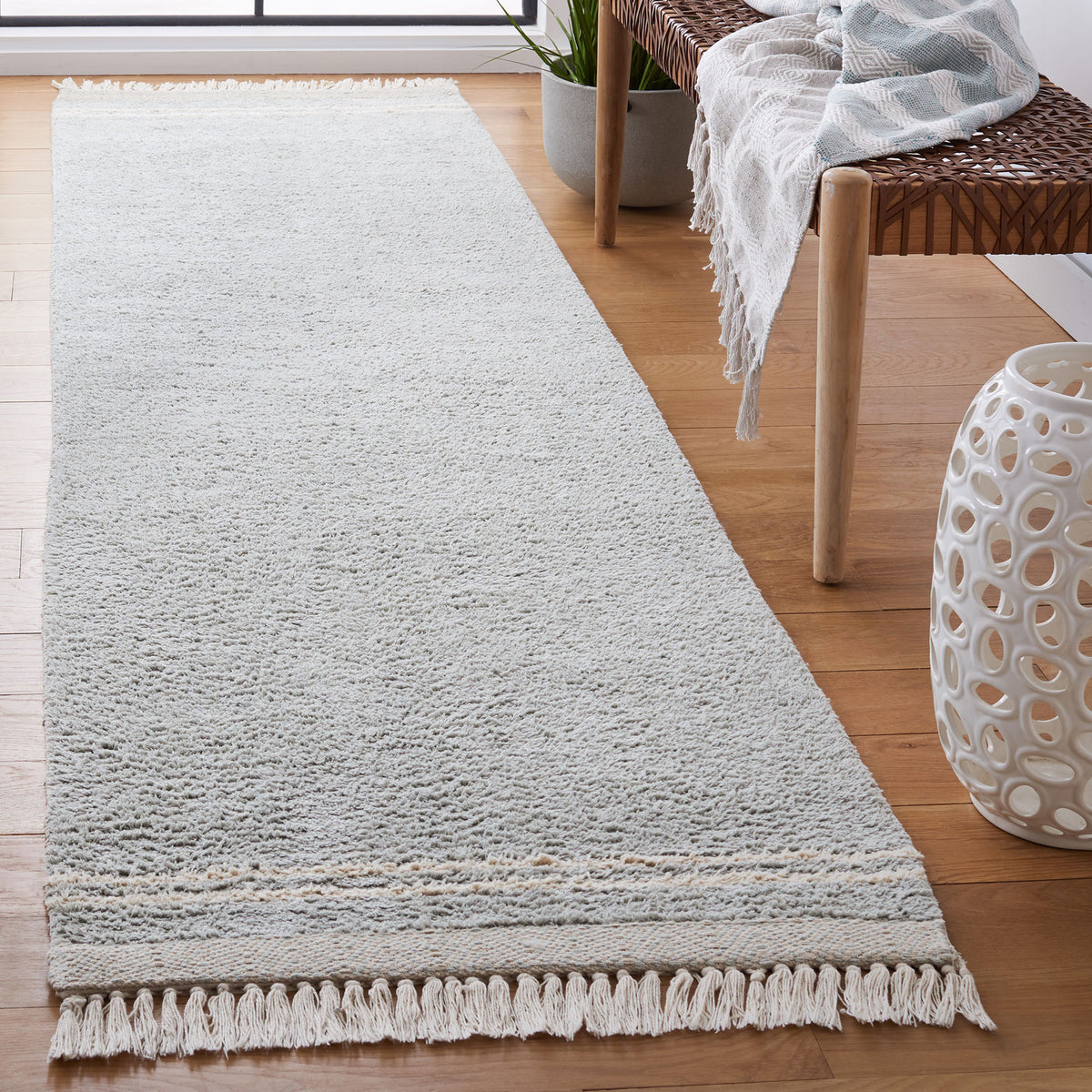Breezy light blue and ivory runner rug with soft texture, subtle banding, and tasseled ends || ECR211J-29 || front_angle_room