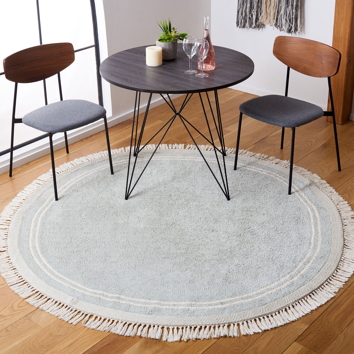Round light blue rug with ivory border and tassel fringe under a dining set. || ECR211J-6R || top_room