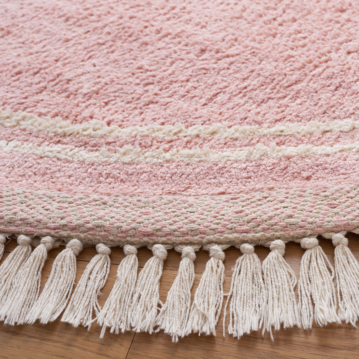 Plush pink pile with ivory border accents and tasseled fringe craftsmanship. || ECR211U-6R || detail_room