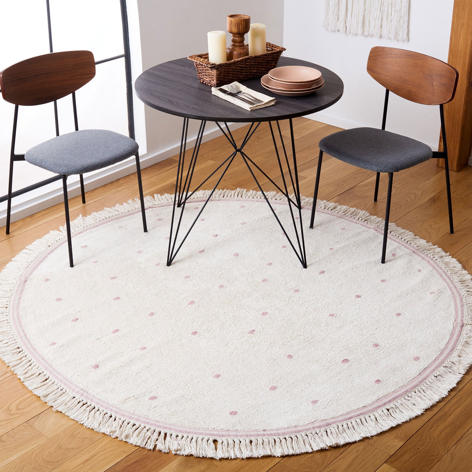 Round ivory rug with pink polka dots anchors a dining nook; fringed border adds charm. || ECR212U-6R || top_room