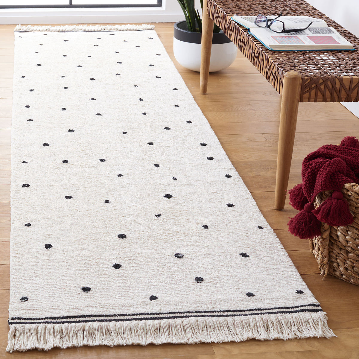Textured ivory runner with black polka dots and fringe adds playful charm to a light, airy room || ECR212Z-29 || top_angle_room