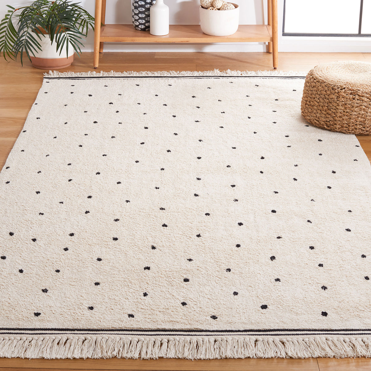 Scandi-inspired ivory rug with black dots and tasseled borders lends easy, relaxed style. || ECR212Z-5 || front_angle_room