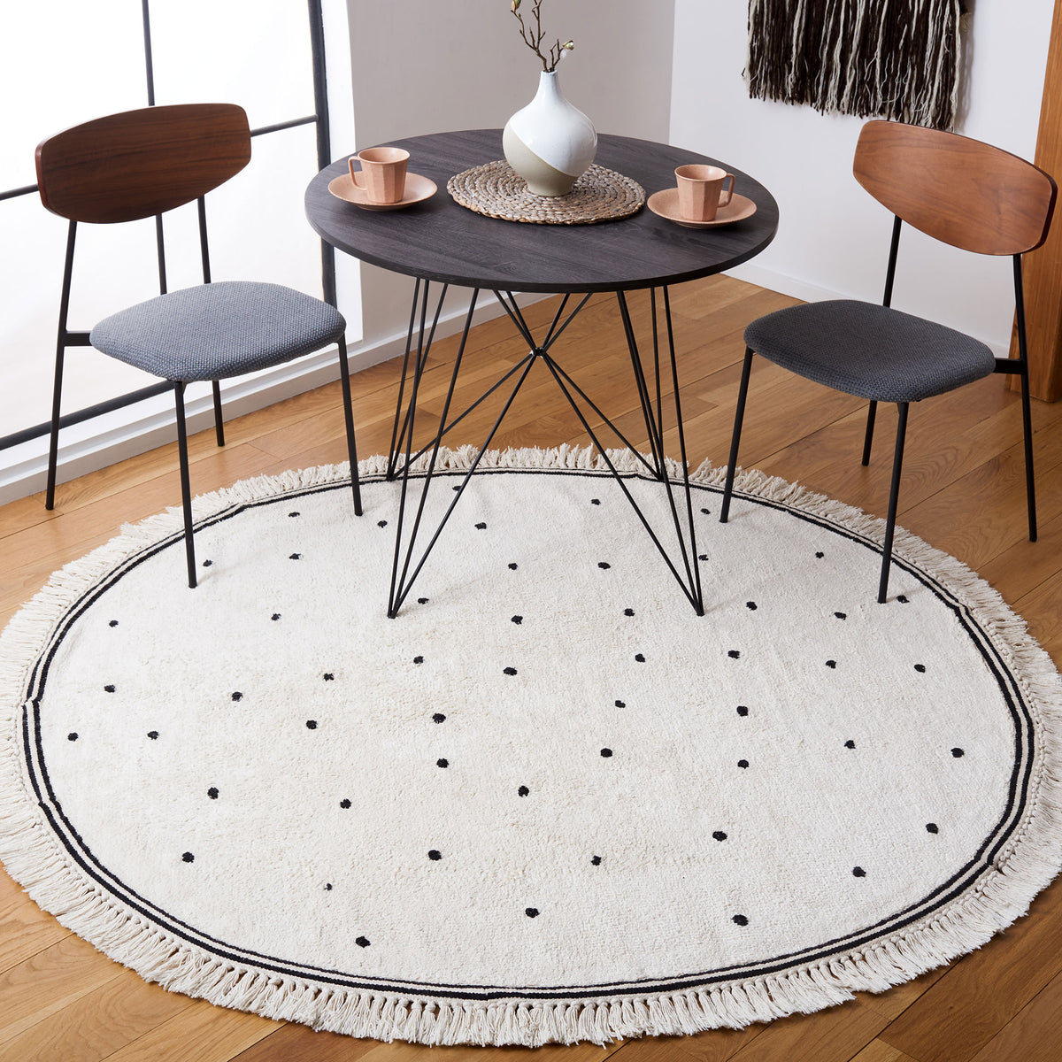 Cozy round ivory rug with black polka dots and tassel fringe, perfect under a small dining set || ECR212Z-6R || top_room