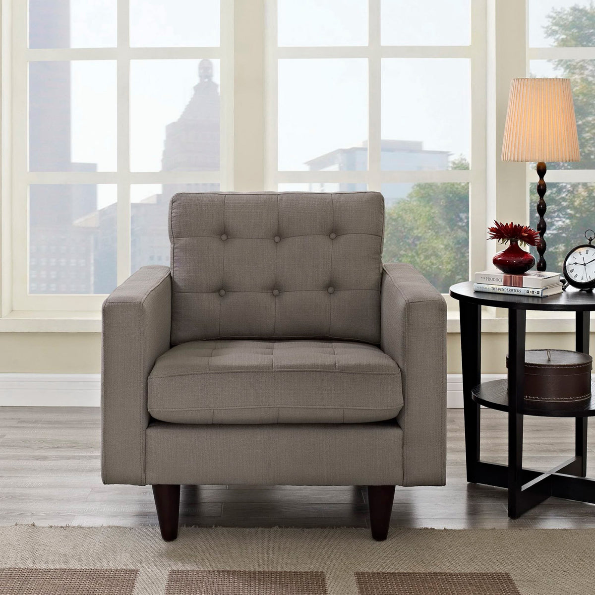 A tufted gray back and plush seat make this armchair an inviting place to relax