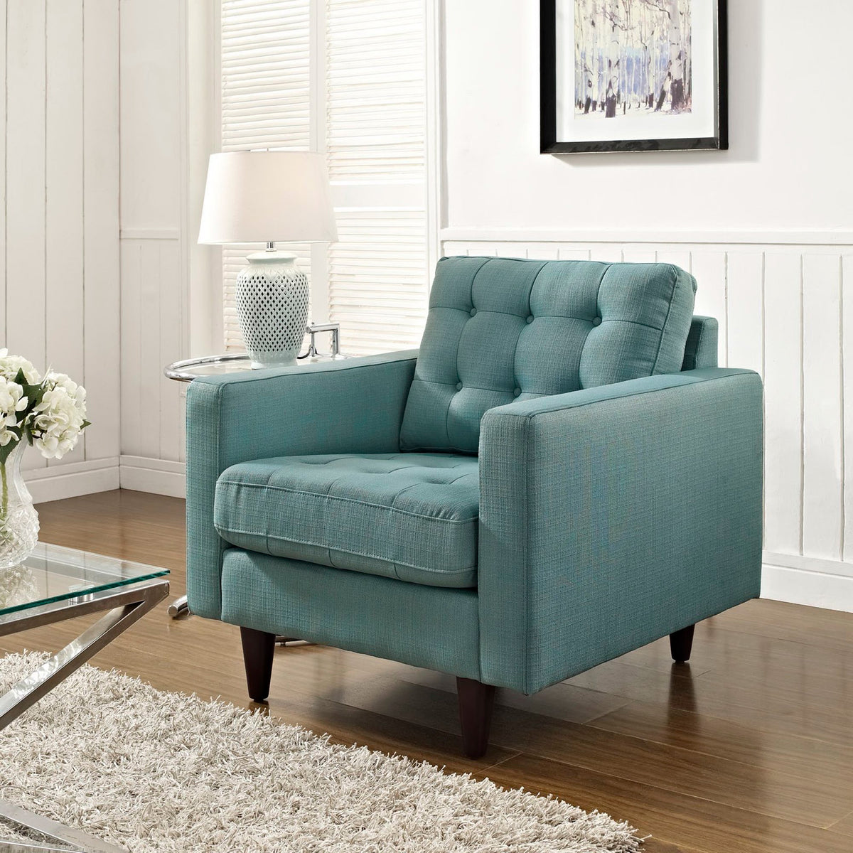 Teal-blue upholstery and tufted cushions add a lively touch to a bright living space