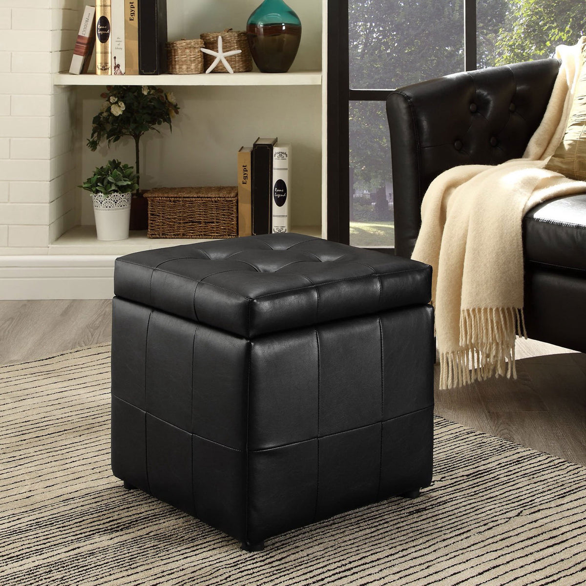 Volt black storage ottoman adding sleek, tailored comfort to a contemporary living room setting || EEI-1044-BLK || front_angle_room