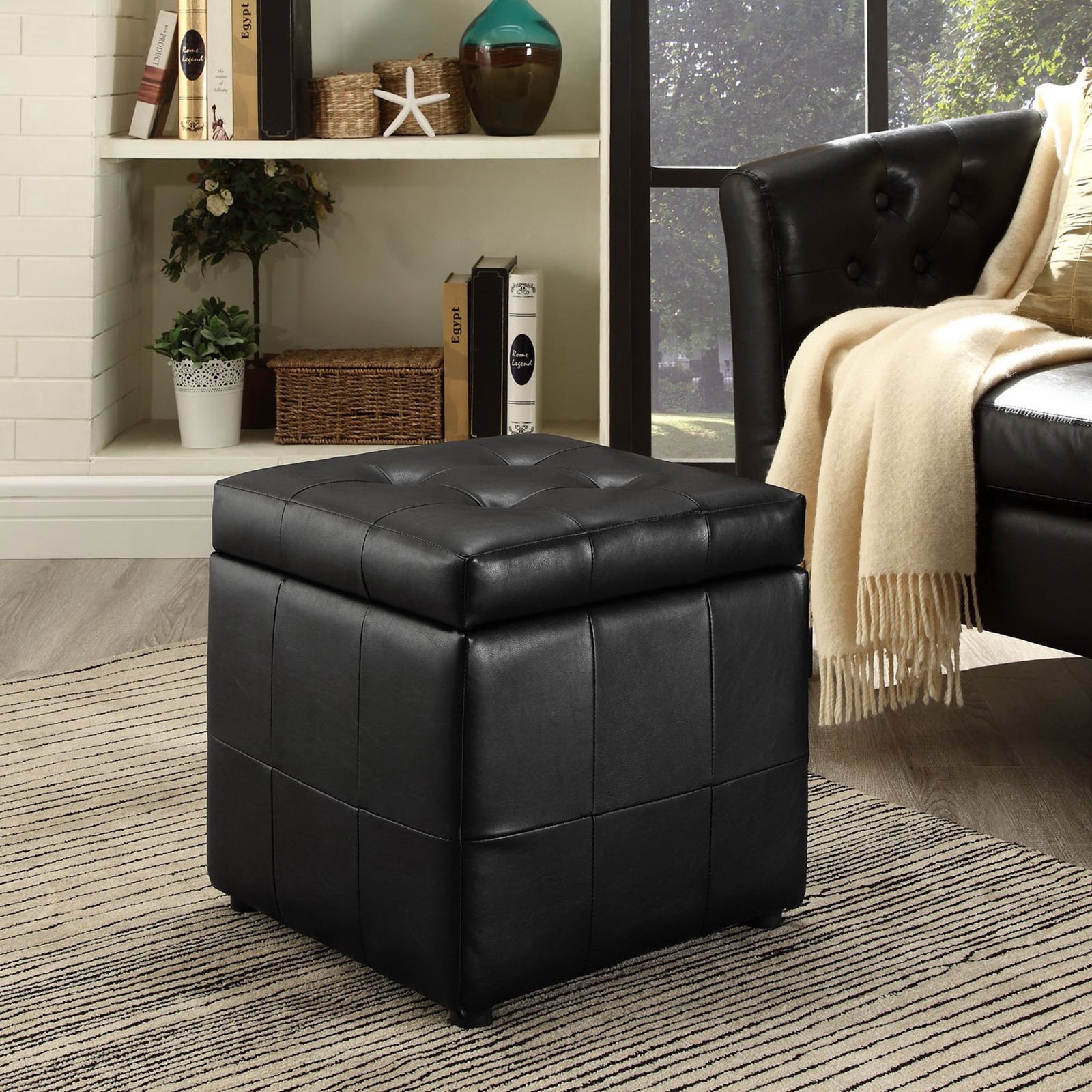 Volt black storage ottoman adding sleek, tailored comfort to a contemporary living room setting || EEI-1044-BLK || front_angle_room