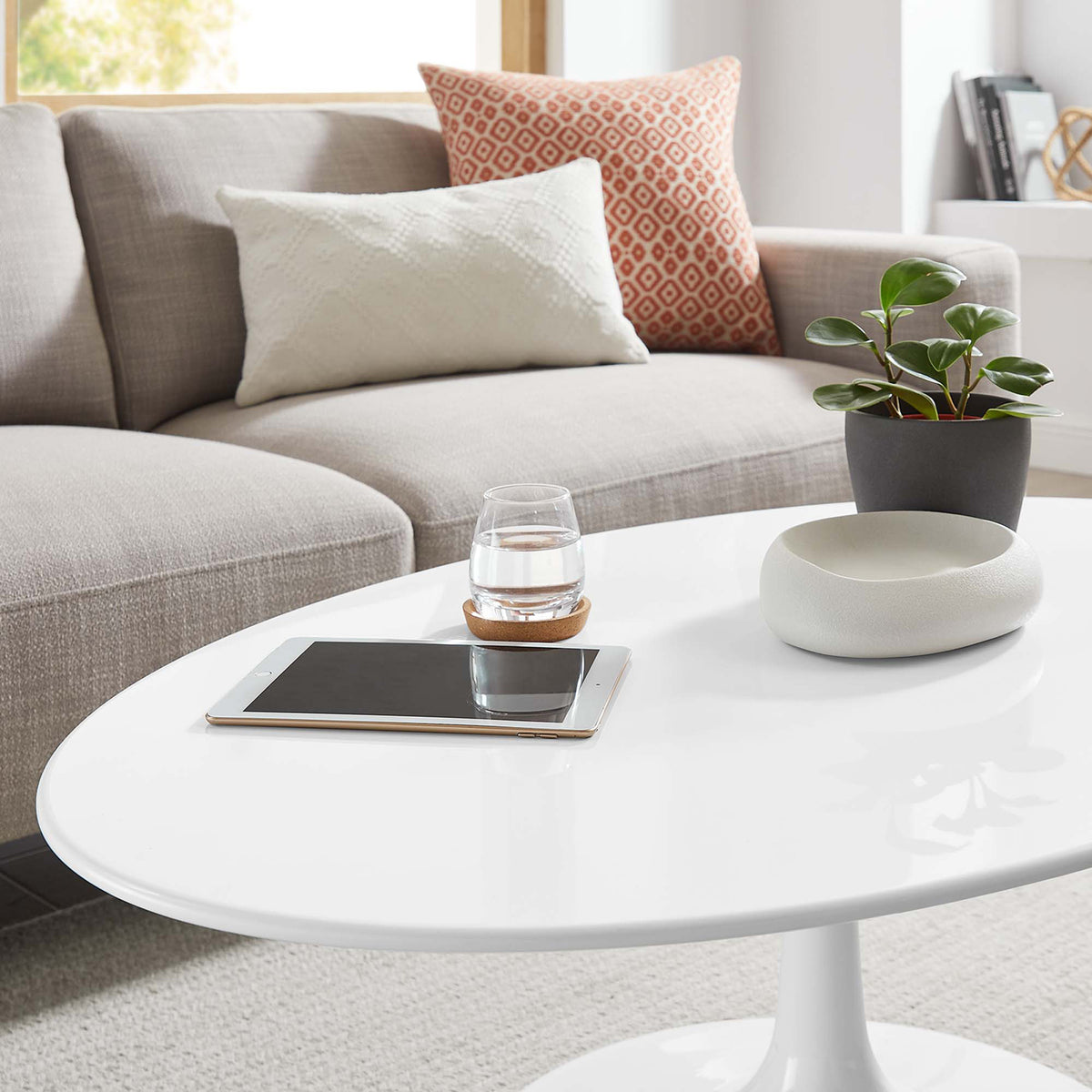 A glossy white surface offers a refined place for drinks, books, and decor.